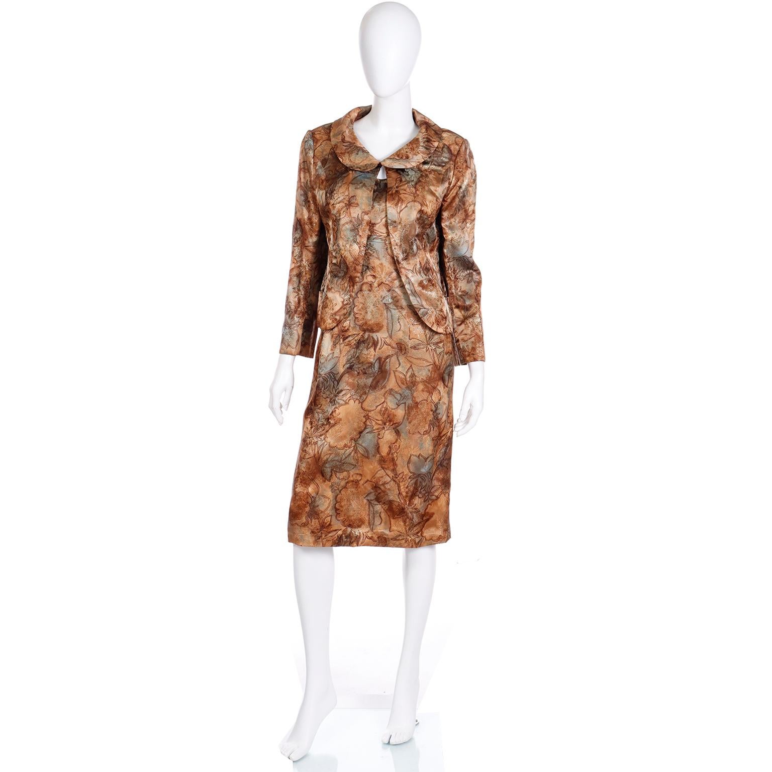 This is such a pretty vintage 1960's  Helen Rose silk satin, abstract watercolor floral print dress with a matching jacket. The dress is in shades of copper, brown, and dusty blue with gold metallic thread details, The jacket has shoulder pads, a