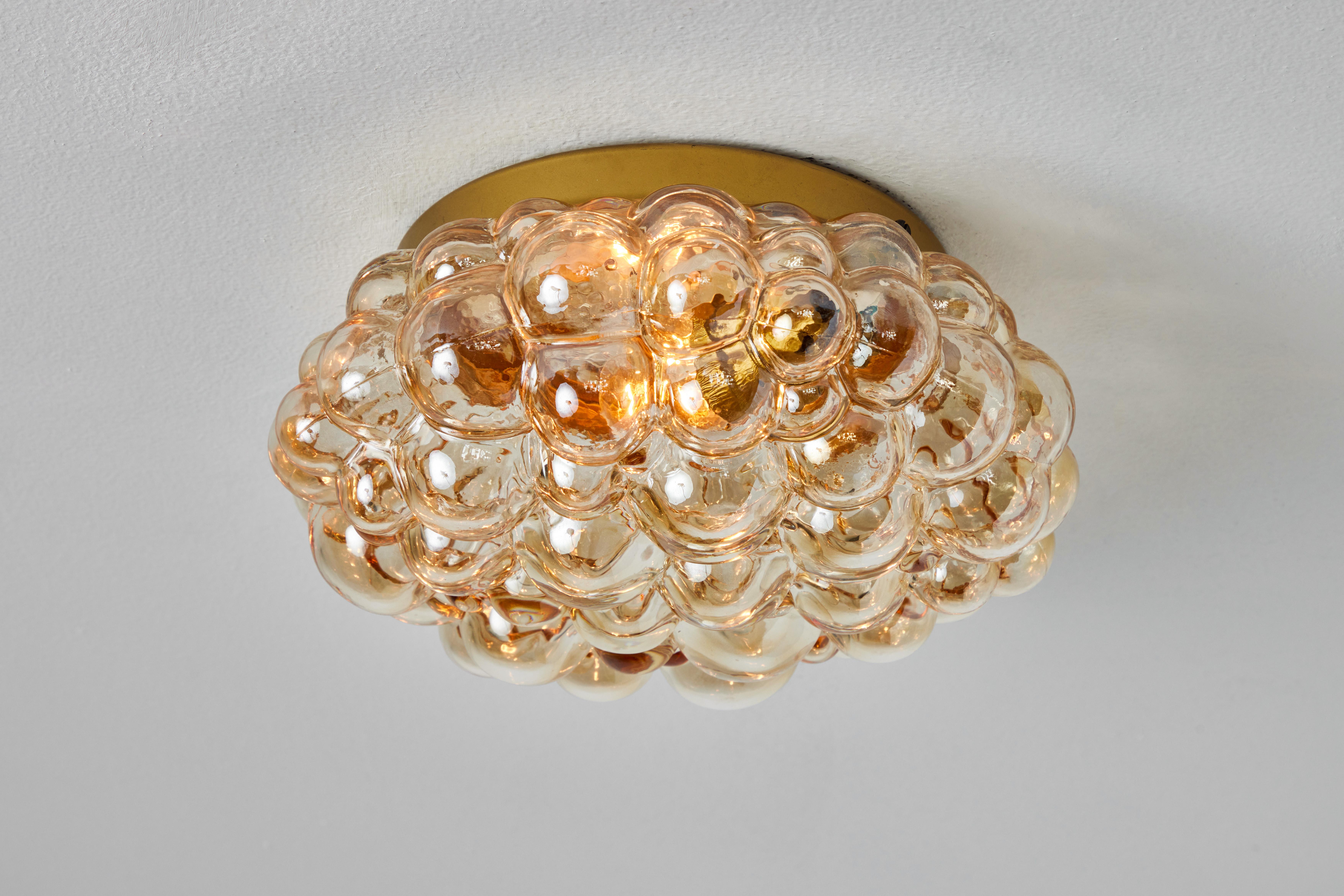 1960s Helena Tynell Model #A664 Amber Bubble Glass Flush Mount for Limburg. Executed in thick and heavy textured amber bubble glass and painted metal mount. Can be mounted on the ceiling or used as a wall lamp. 

Fabricated in Limburg, Germany circa