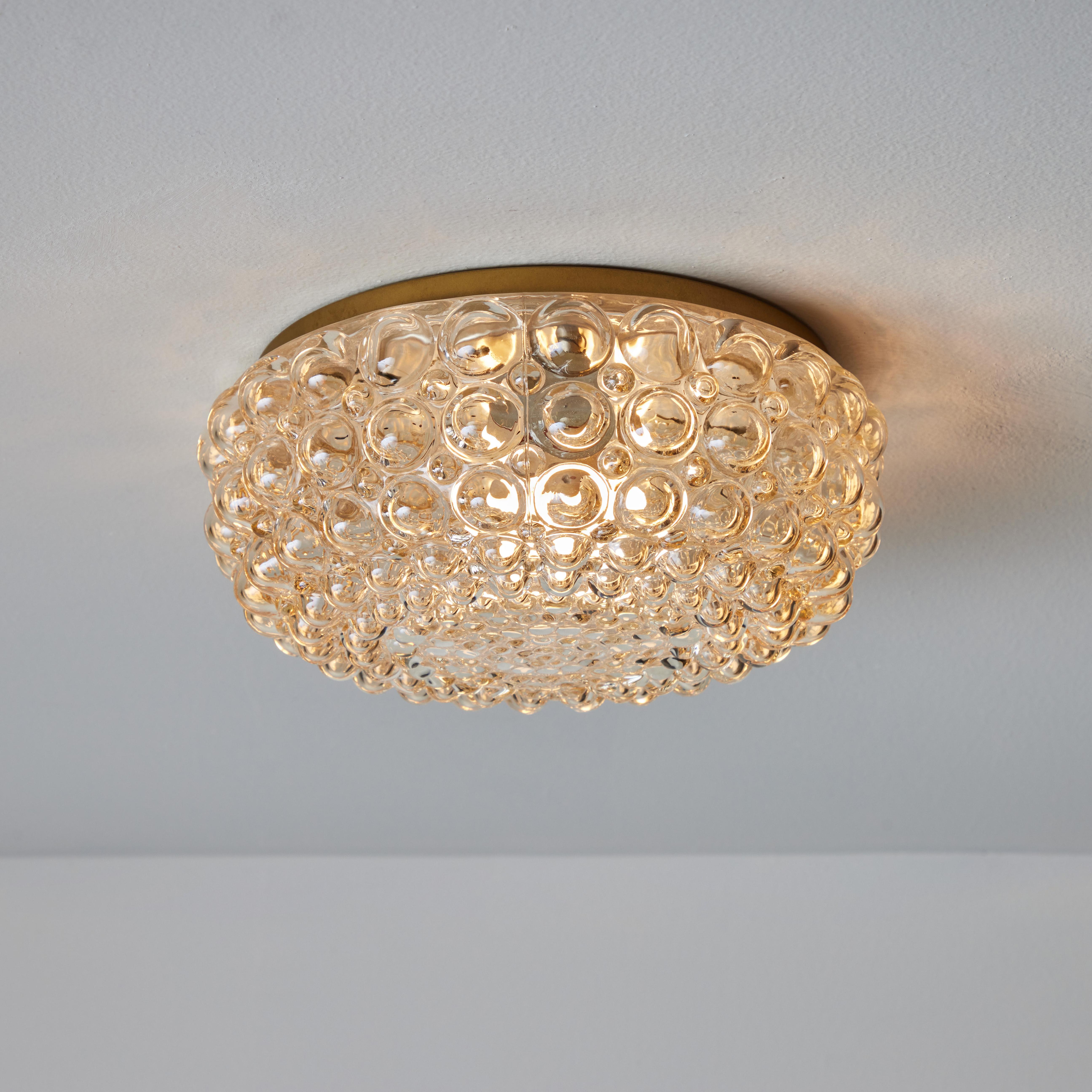 1960s Helena Tynell Model #A665 Bubble Glass Lamp for Limburg. Executed in thick and heavy textured bubble glass with brass finished metal mounting structure. Can be used as a wall lamp or flush mount. Produced in Limburg, Germany circa the