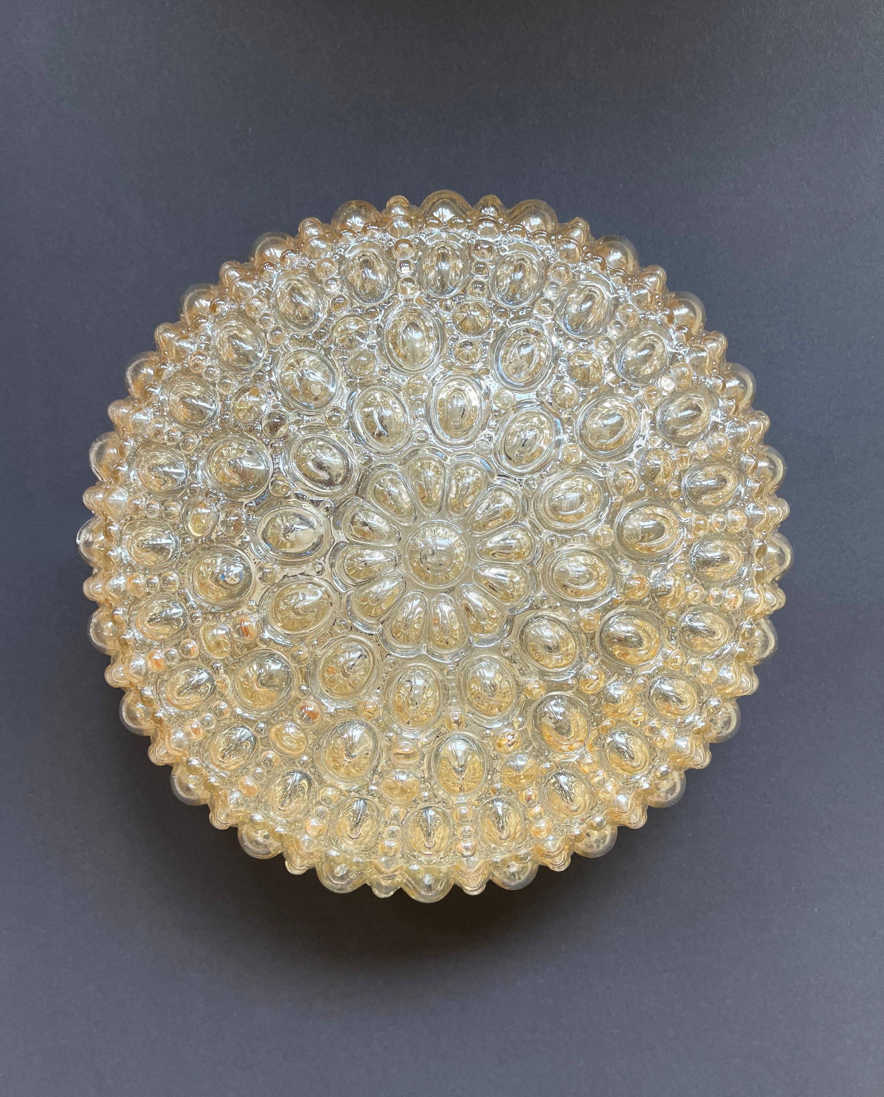 Magnificent, flush base ceiling or wall lamp by 'Glashütte Limburg', Germans famous mid century manufacturer of high-end design lighting.
Helena Tynell is one of the artists who created the most beautiful lighting of that time: here in a sea urchin