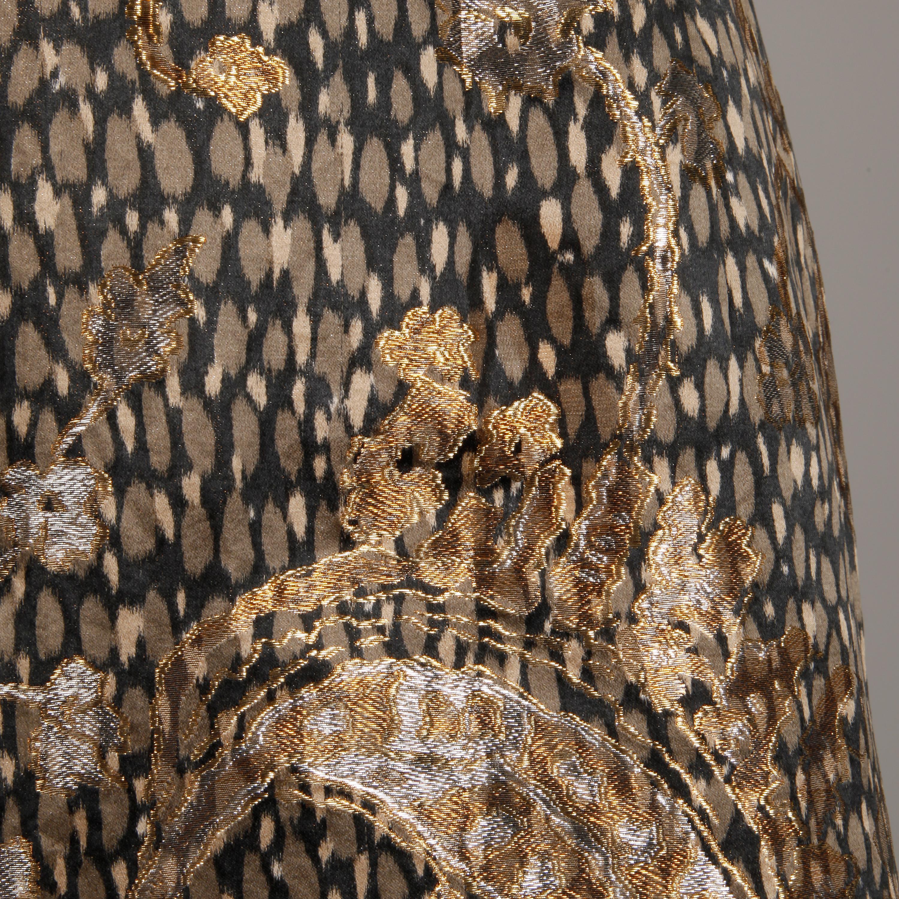 Absolutely stunning 1960s vintage silk satin cocktail dress by Helga. Metallic brocade paisley design over gray silk animal print. Nipped waist with bow detail. Stunning construction with a weighted bust and hand stitching throughout. Partially
