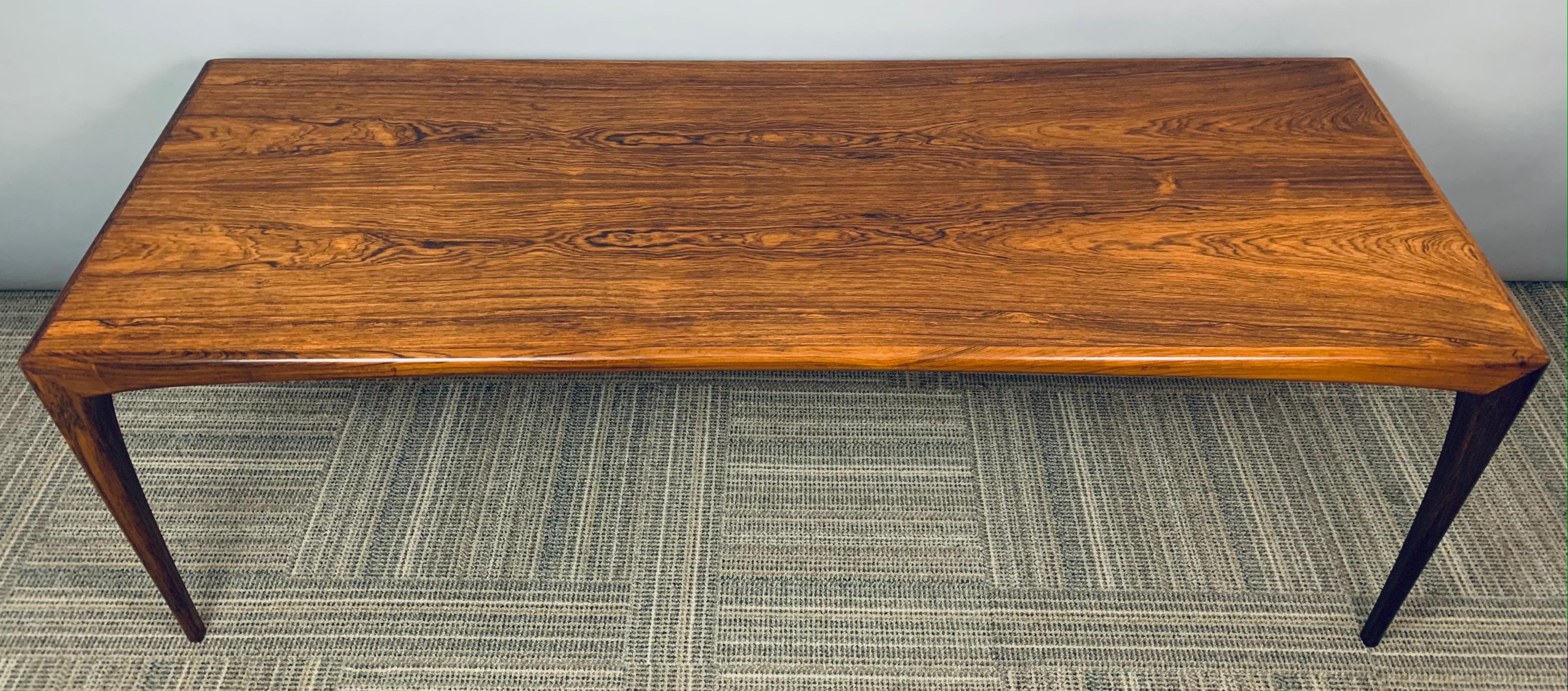1960s midcentury rosewood coffee table designed by Danish designer Erling Torvits and manufactured by Heltborg Møbler. A beautiful coffee table with feature sculpted solid rosewood legs and a wonderful deep grain patina on the top of the table. In