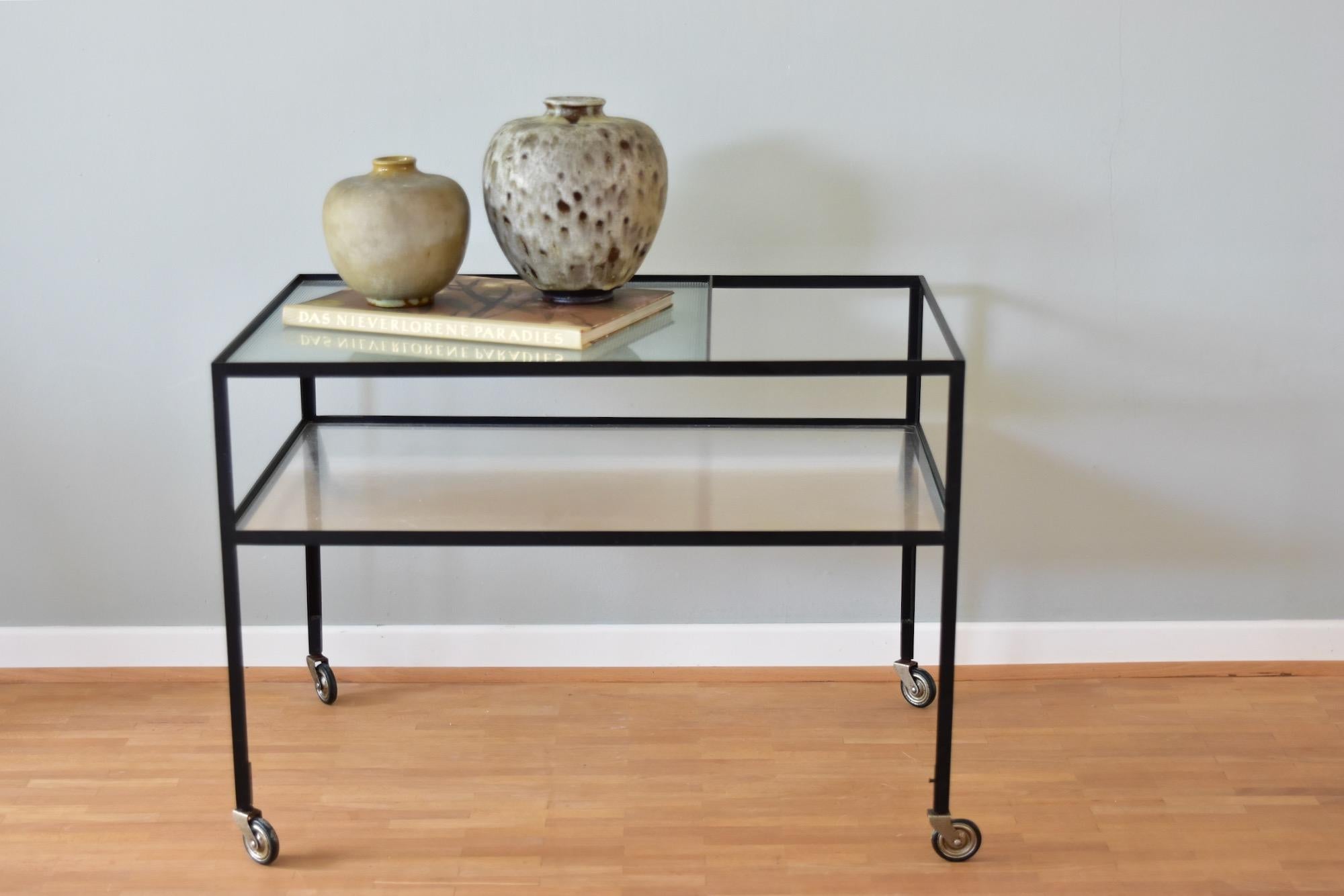 Vintage Herbert Hirche 1960's black colored metal and original corrugated glass serving cart. Produced by Christian Holzäpfel KG Germany. 
Nice vintage condition.