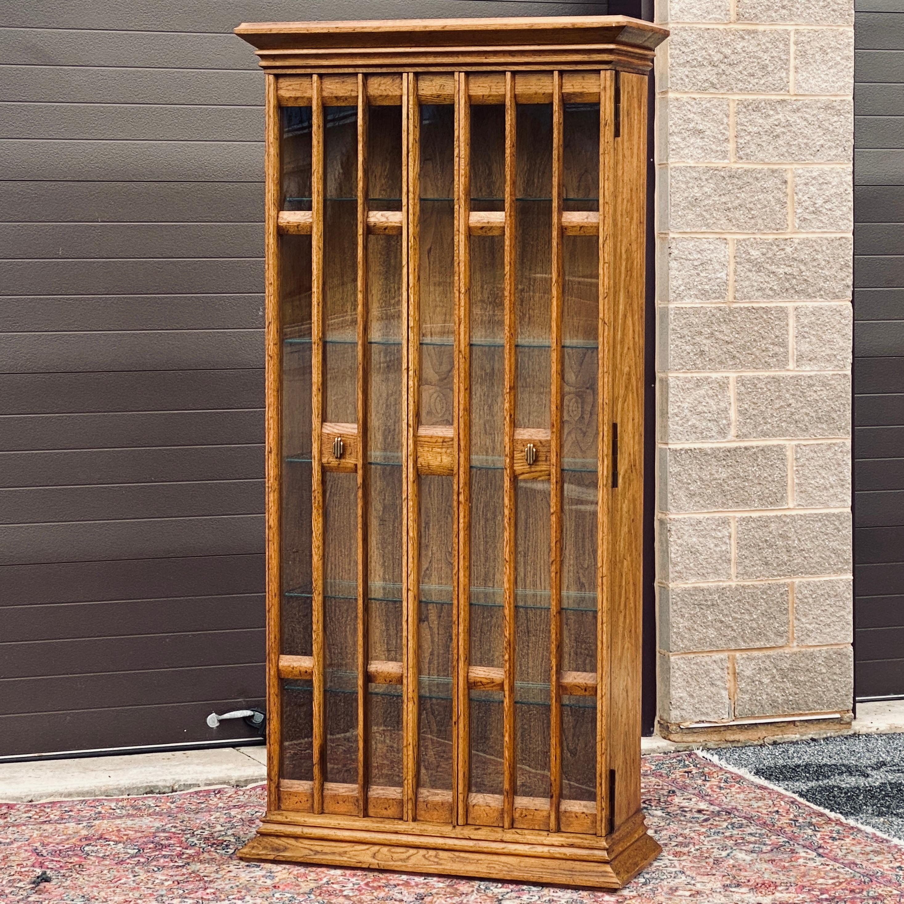 Vintage china cabinet by Heritage Furniture with unique full length doors and two interior light fixtures. 
Five adjustable glass shelves measuring approximately 31.75” x 10.5”
Interior space approximately 32”w x 10.5”d x 70”h
Fixed center panel