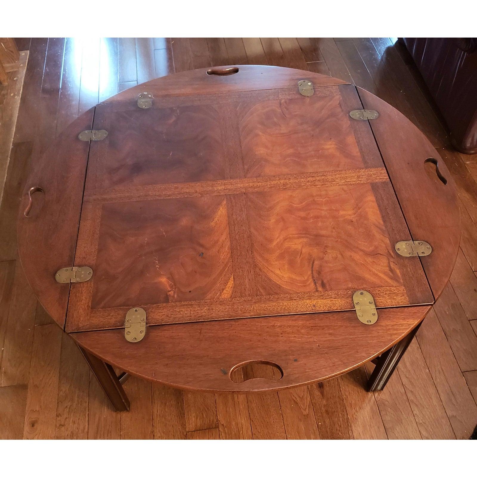 Beautiful classic Heritage Butler's table. Finest quality fixed butler's coffee table in square cut mahogany painstakingly crafted. Fold down arched sides with pierced handles and solid brass hinges. Measurements are 36