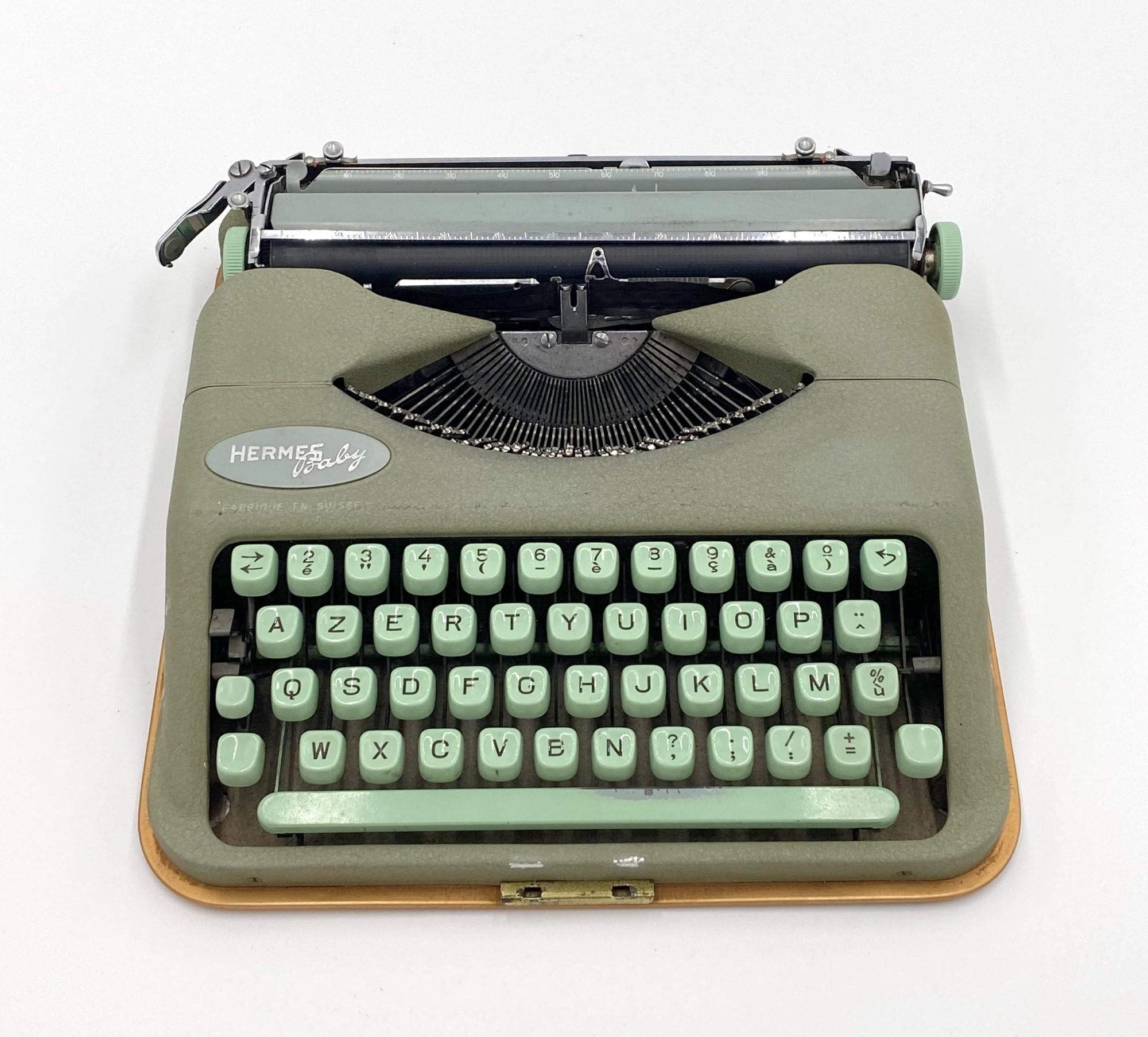 This original 1960s Hermes baby typewriter features a French keyboard. A key for the case, the case and paperwork are included.