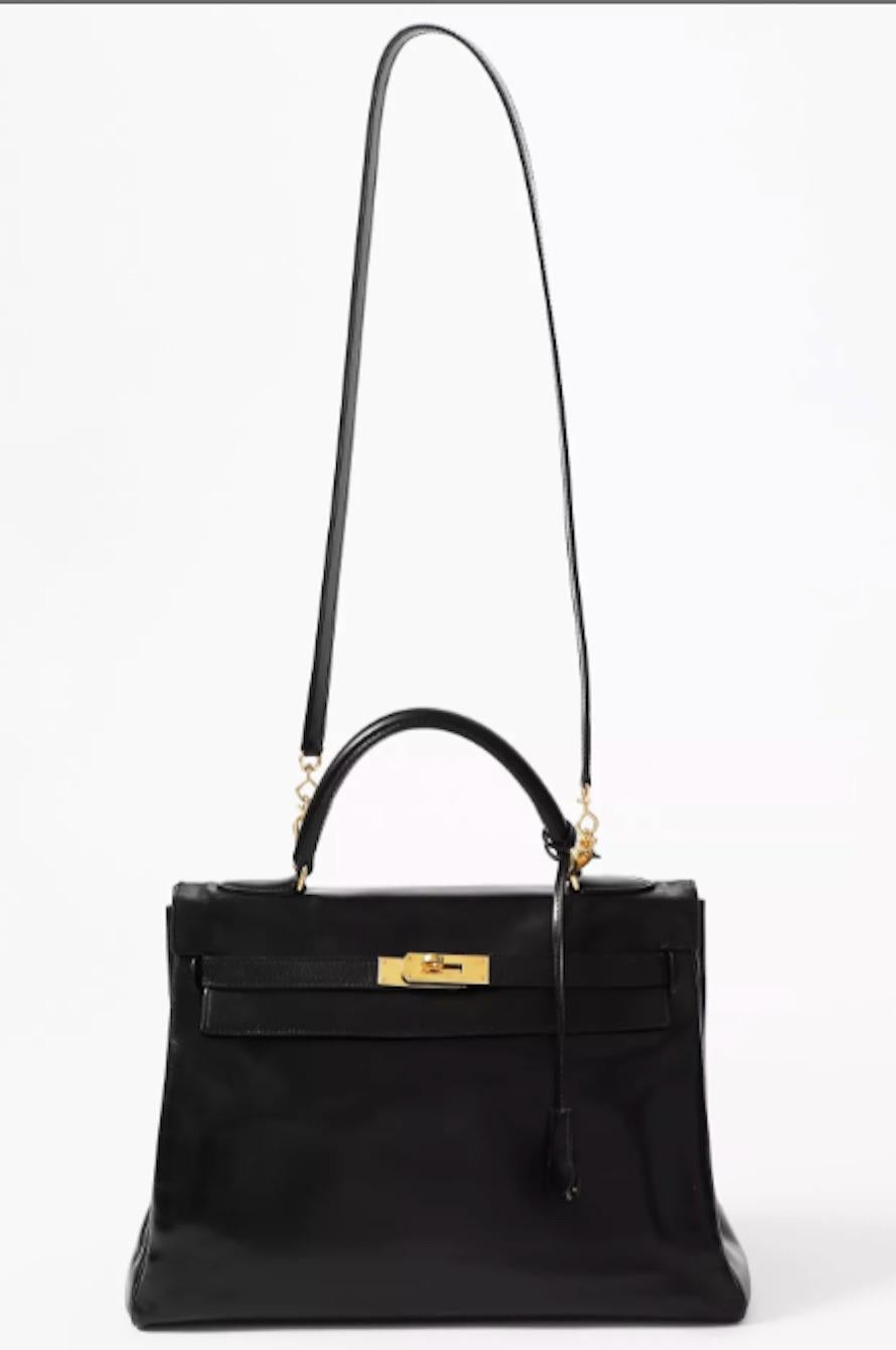 1960s Hermès black box calf leather Kelly retourné 32 tote bag featuring a foldover top with push-lock closure, a top handle with removable shoulder/crossbody strap (not Hermes stamped), plated gold-tone hardware and an internal pockets, with his