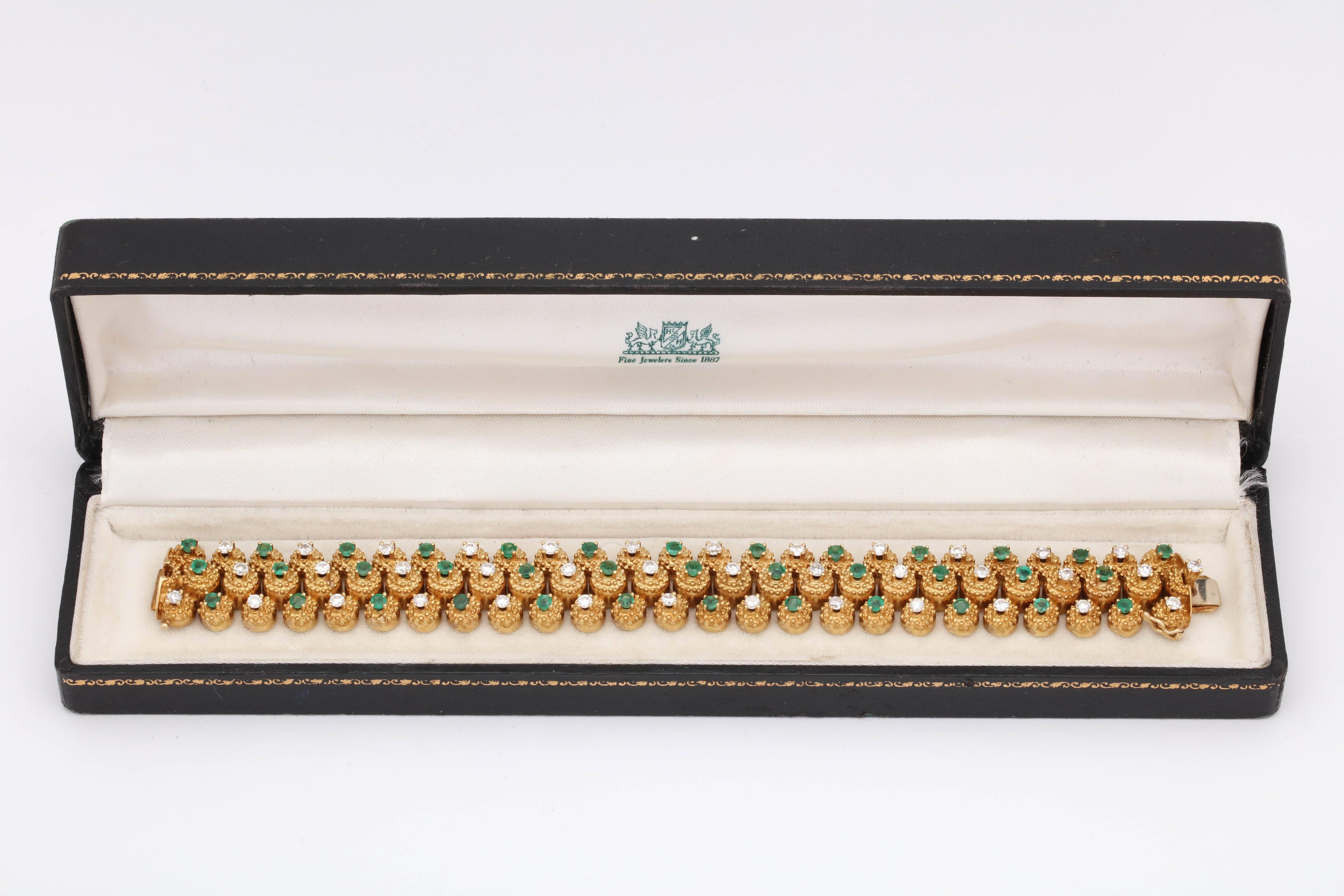 One Ladies 18kt Triple Row Yellow Gold Highly Flexible And Articulated Link Bracelet Embellished With Thirty Seven Beautiful Color Faceted Emeralds Weighing Approximately=3 Cts Total Weight And Also Designed With Thirty Eight High Quality Full cut