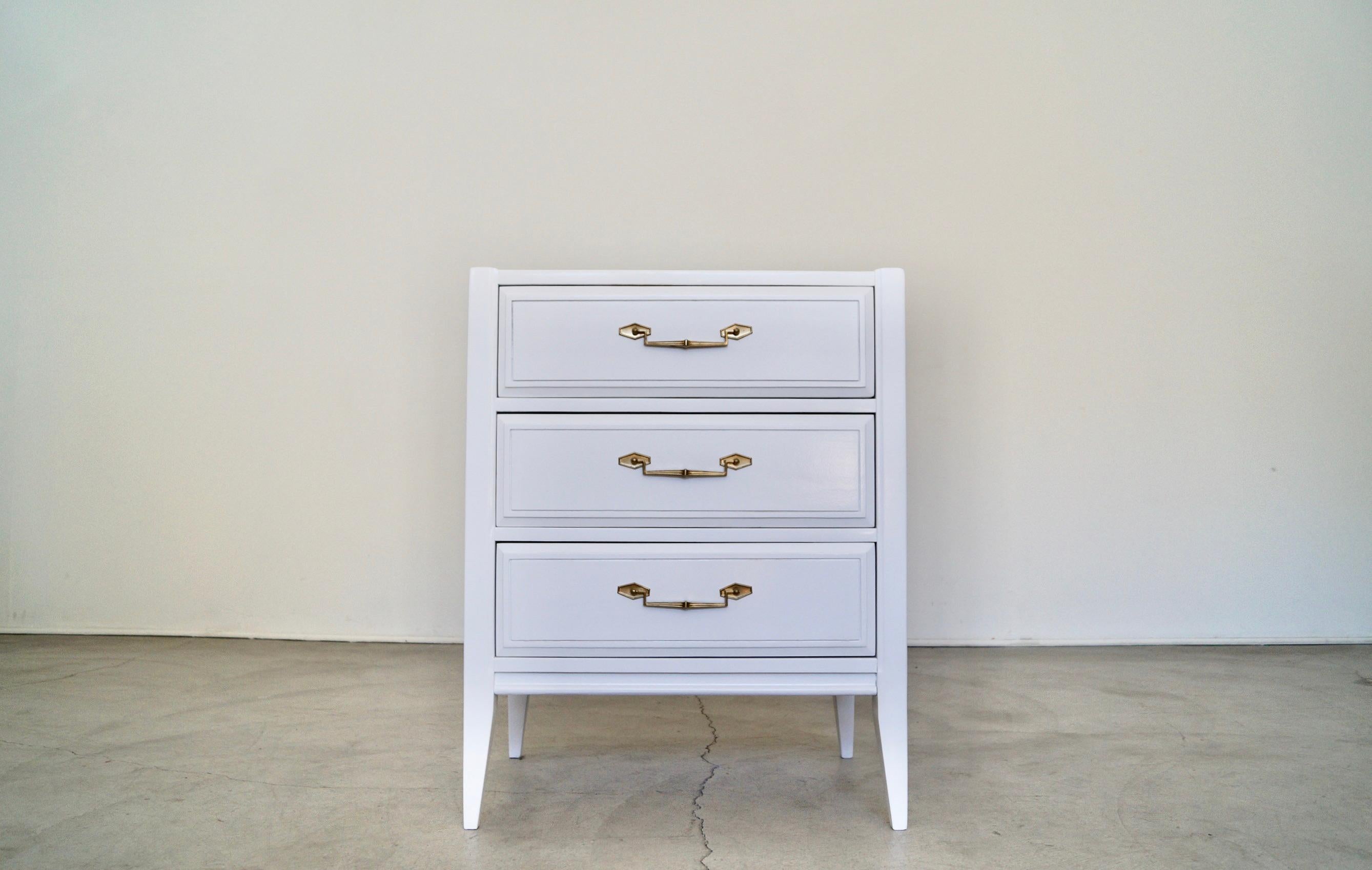 Vintage Midcentury dresser for sale. Manufactured by Basic Witz, and has been professionally refinished in white. It has the original solid brass hardware, and is a high-quality piece from the 1960’s. It has elegant clean lines with tapered legs,