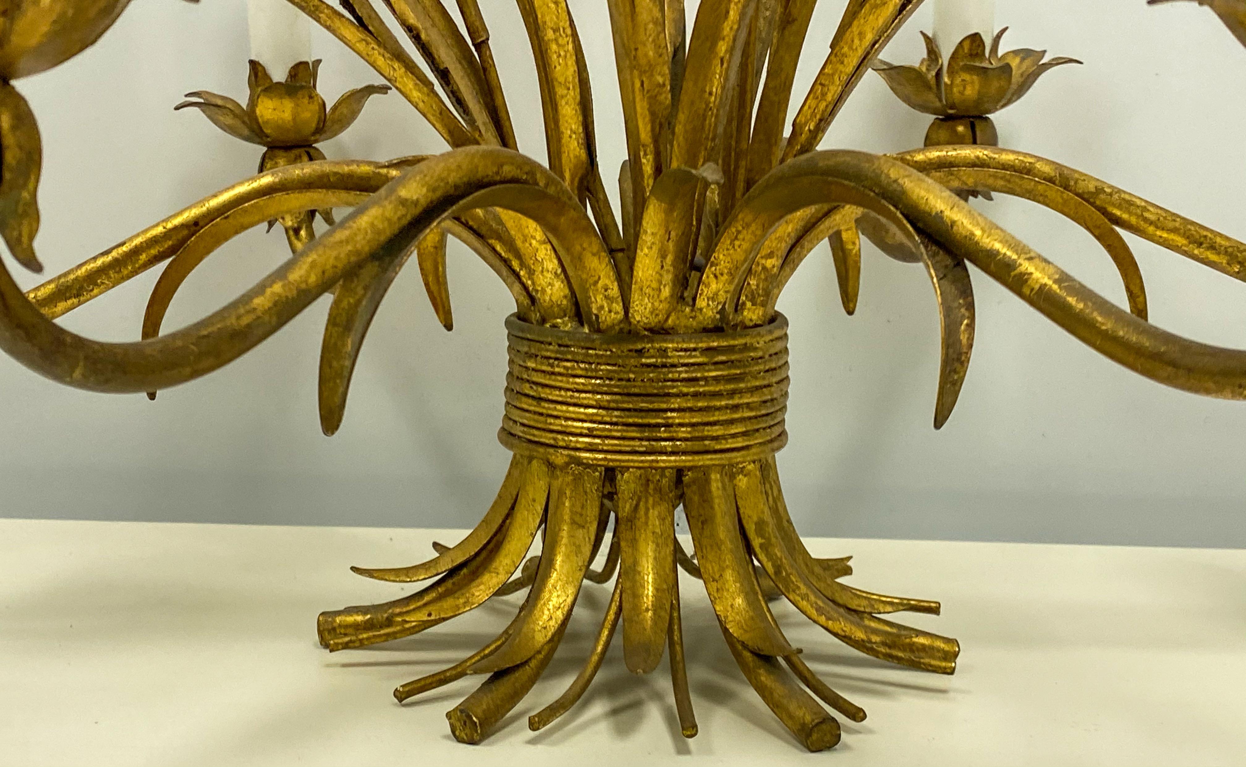 This is a 1960s Hollywood Regency Era tole gilt metal wheat sheaf chandelier. It has six arms and is in working order.