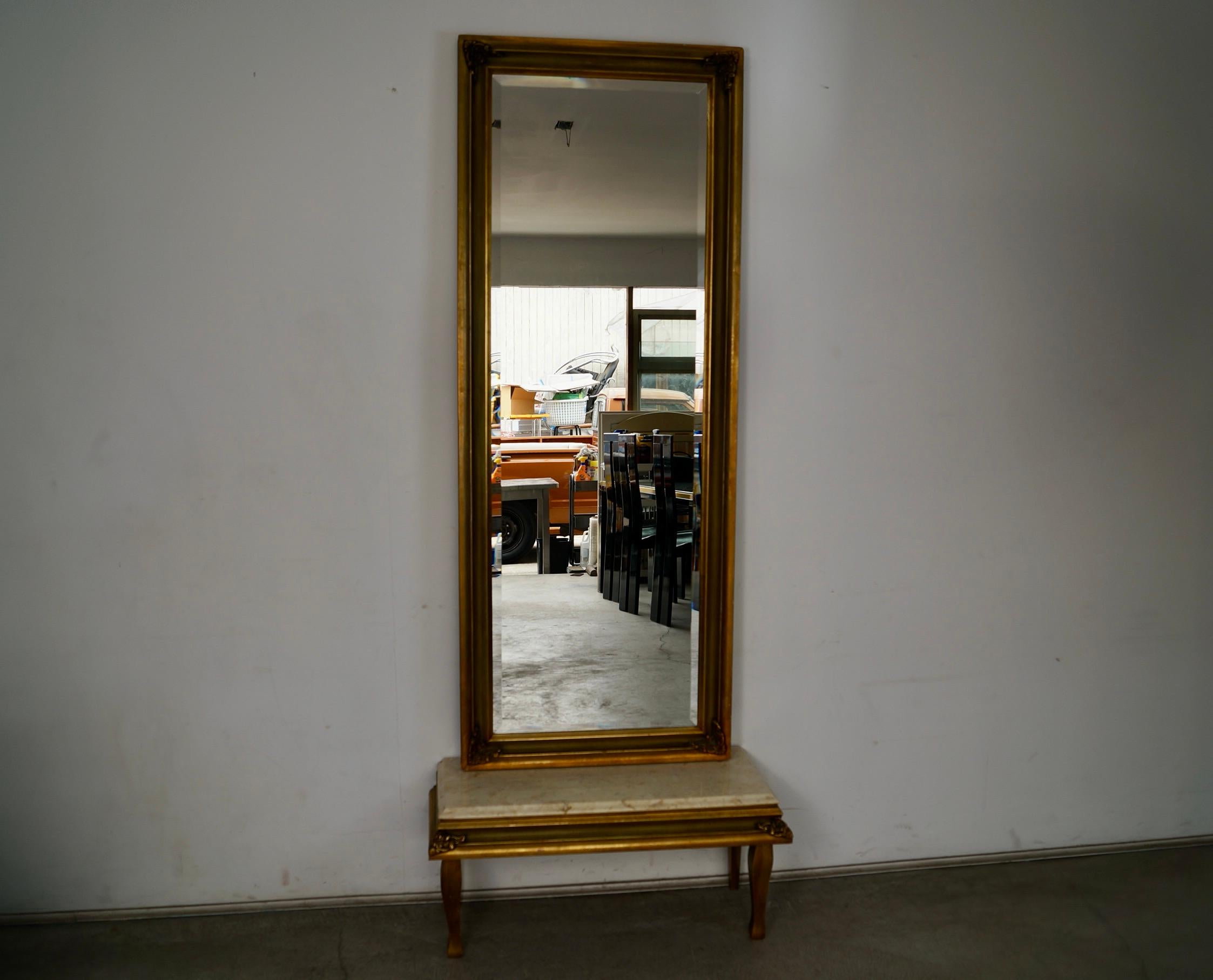 Vintage Hollywood Regency French Renaissance pier mirror for sale. It's a large full-length mirror with a stand in a faux marble resin top. These are two separate pieces with the mirror being able to be mounted, and the bottom stand. This piece is