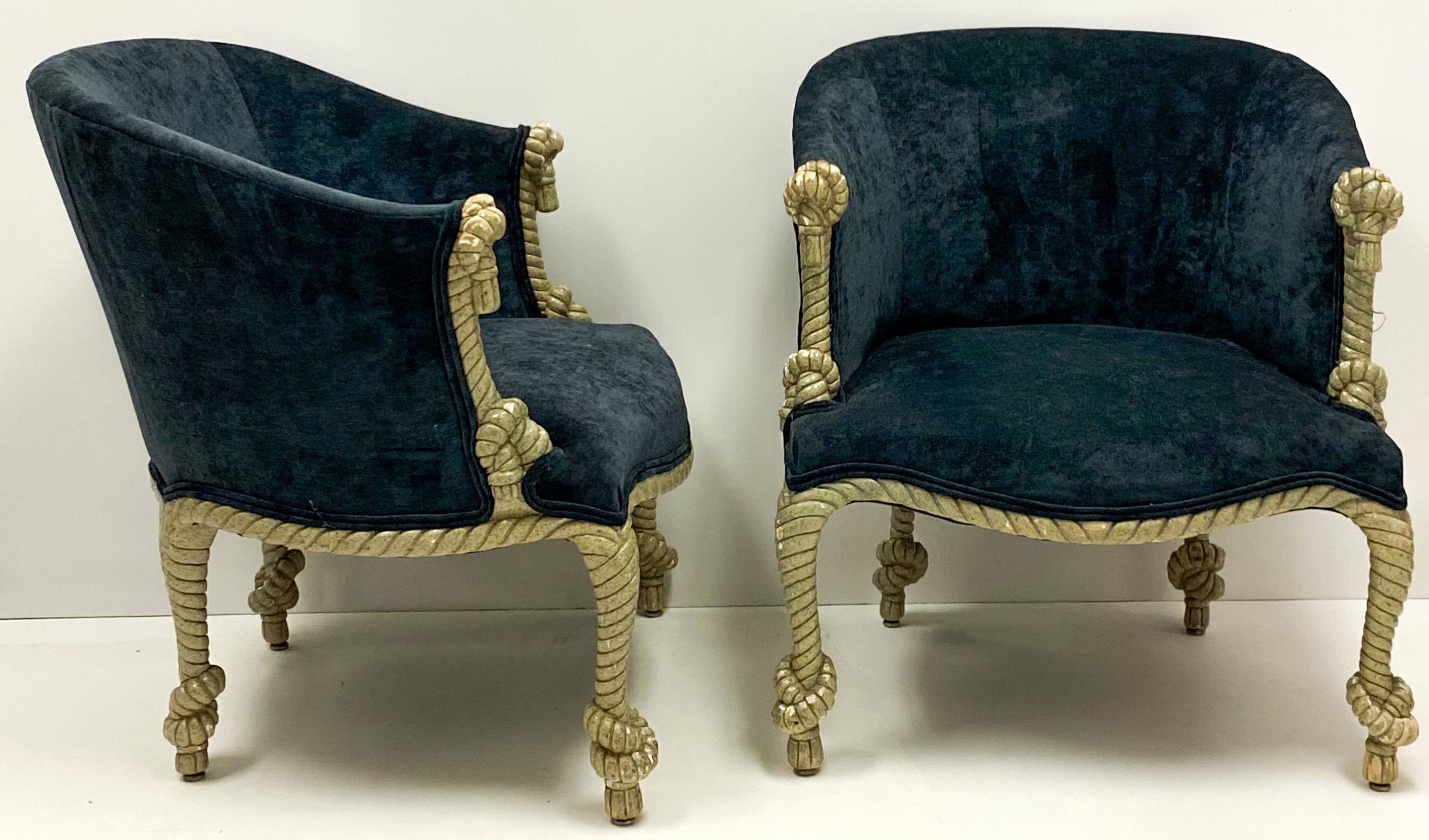 This is a pair of Hollywood Regency gilt and tassel pair of velvet tub chairs. The frames are gilt gesso over wood. The velvet is a recent addition. They are unmarked and in very good condition.