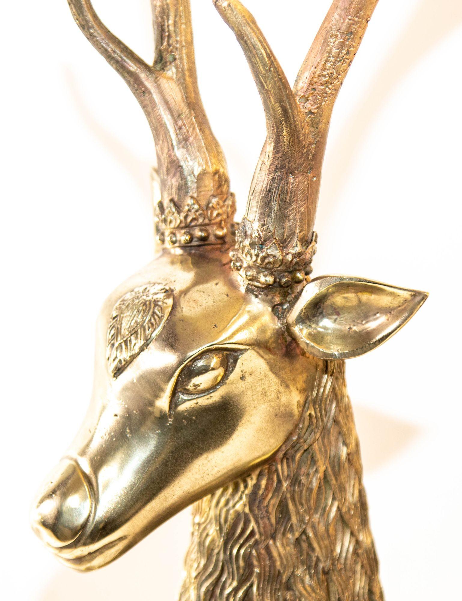 Vintage dramatic and large seated 1960s brass deer with fanciful decoration attributed to Sarreid Ltd.
Large heavy cast brass reclining stag sculpture in solid brass design polished gold color.
Hollywood Regency Large Brass Deer attributed to