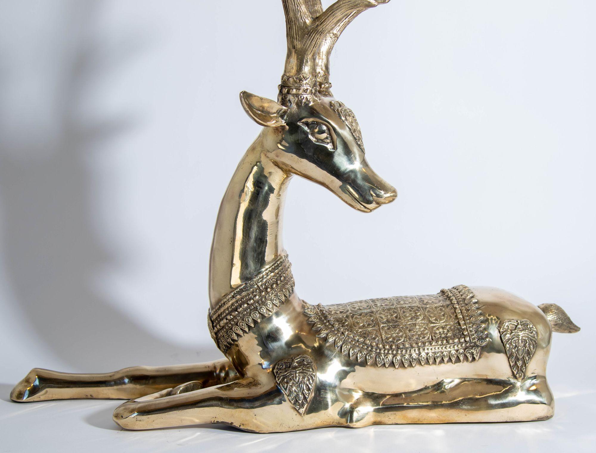 Vintage dramatic and large seated 1960s brass deer with fanciful decoration attributed to Sarreid Ltd.
Large oversized heavy cast brass reclining stag sculpture in solid brass design polished gold color.
Antique gilt cast bronze figure of a