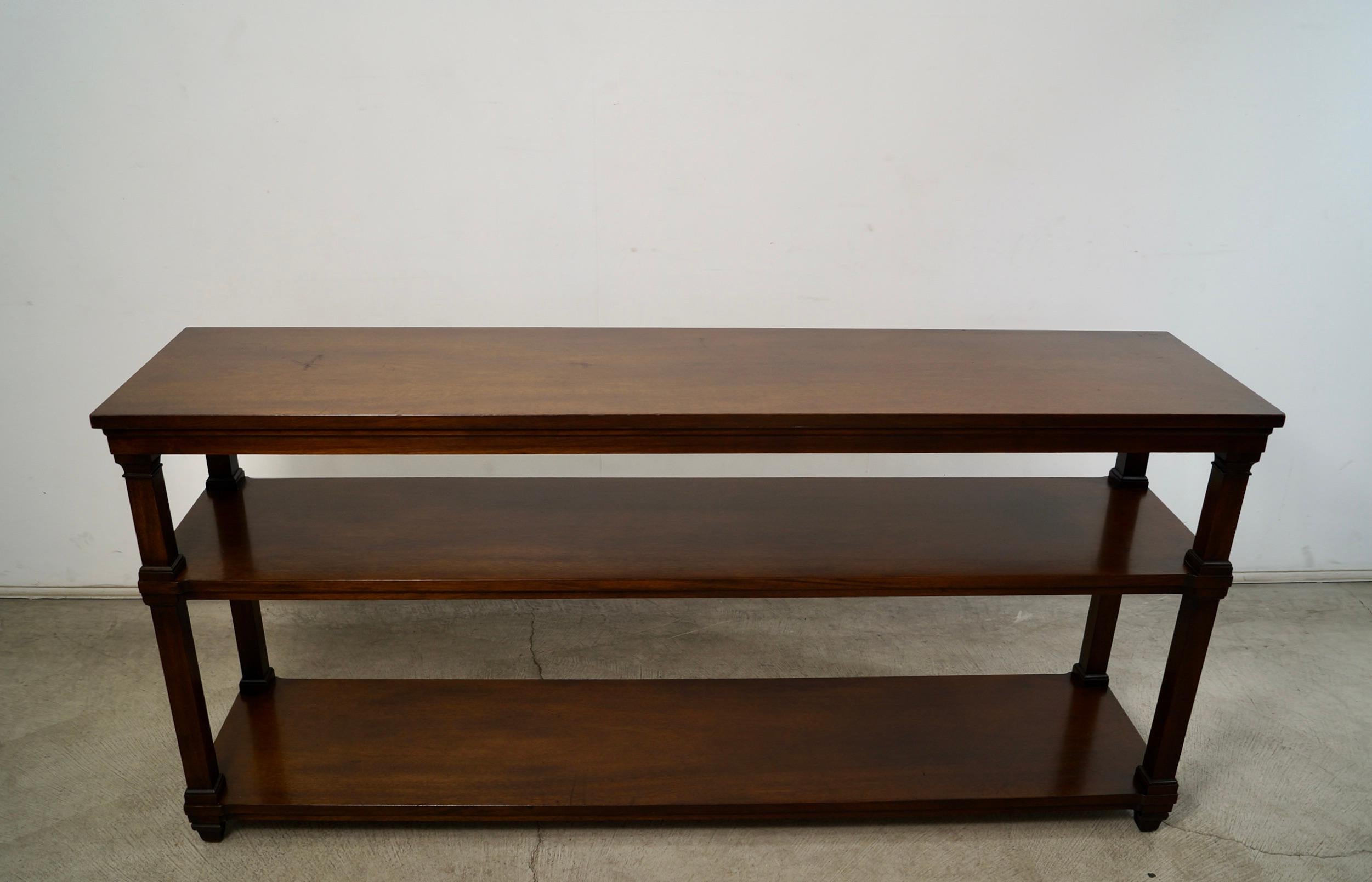 Vintage Midcentury Modern bookshelf for sale. Very solid and well built, and in excellent vintage condition. It's made of walnut, and has a beautiful walnut finish to it. It has a leg in the middle for extra support. It's a long shelf that would