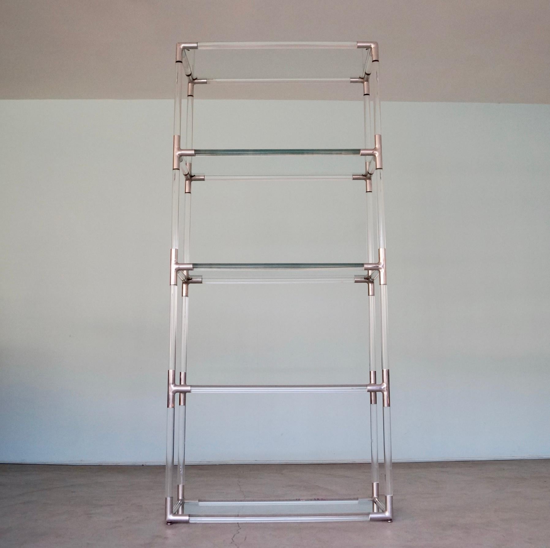 We have this monumental original Mid-Century Modern shelf for sale. It's an original designer etagere by in the manner of lucite king Charles Hollis Jones. It's in amazing showroom condition, and a gorgeous work of art! It's made of lucite with
