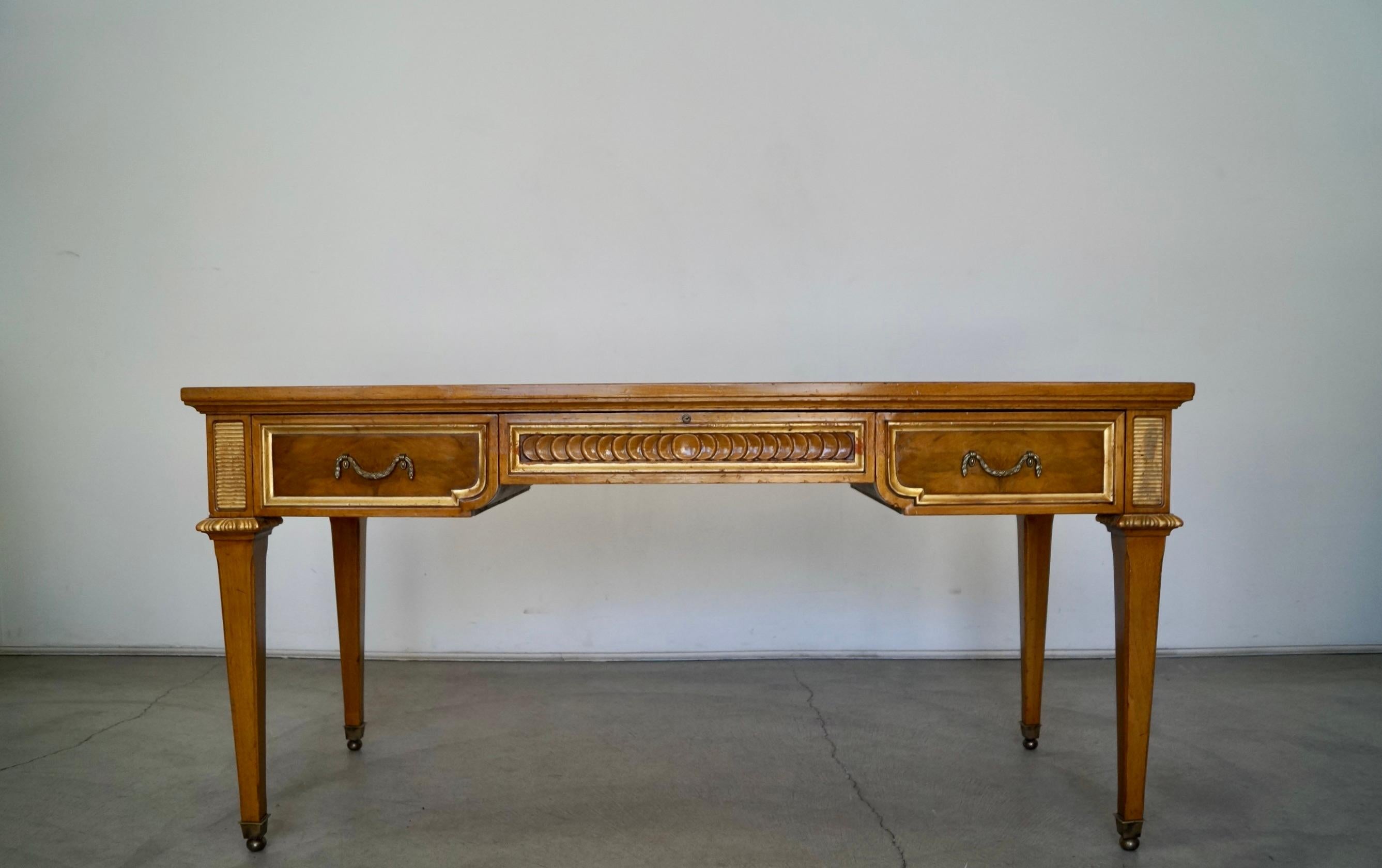 Vintage 1960s Hollywood Regency desk for sale. Manufactured by Karges in the 1960s, and in beautiful vintage condition. Really special writing desk that is really solid and well made. Has a flaming mahogany top with burl with drawers, sides, and
