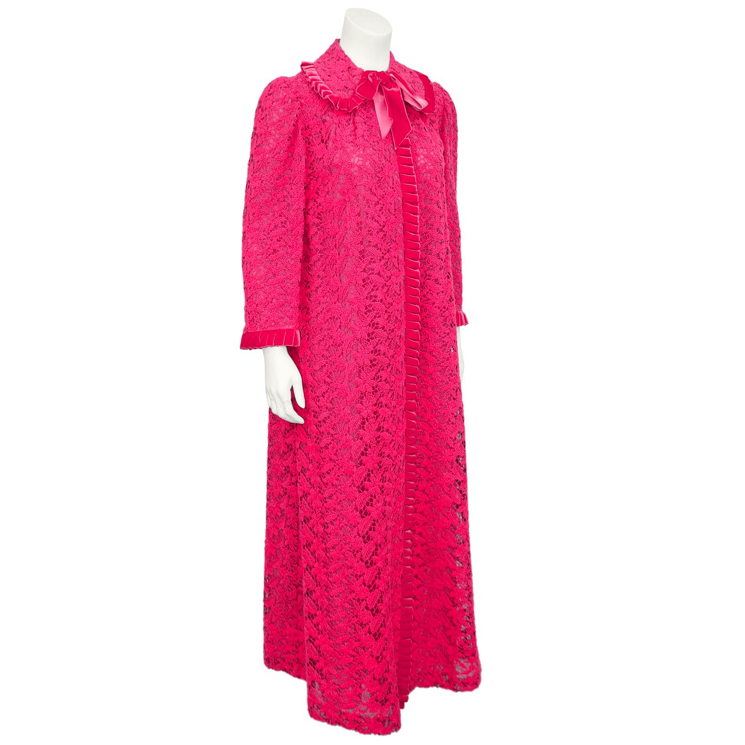 The most darling 1960s duster from Toronto's historic luxury boutique Creeds. Hot pink lace with hot pink pleated velvet trim at collar cuffs and centre seam. Further embellished with a matching hot pink velvet tie at centre of the peter pan collar.