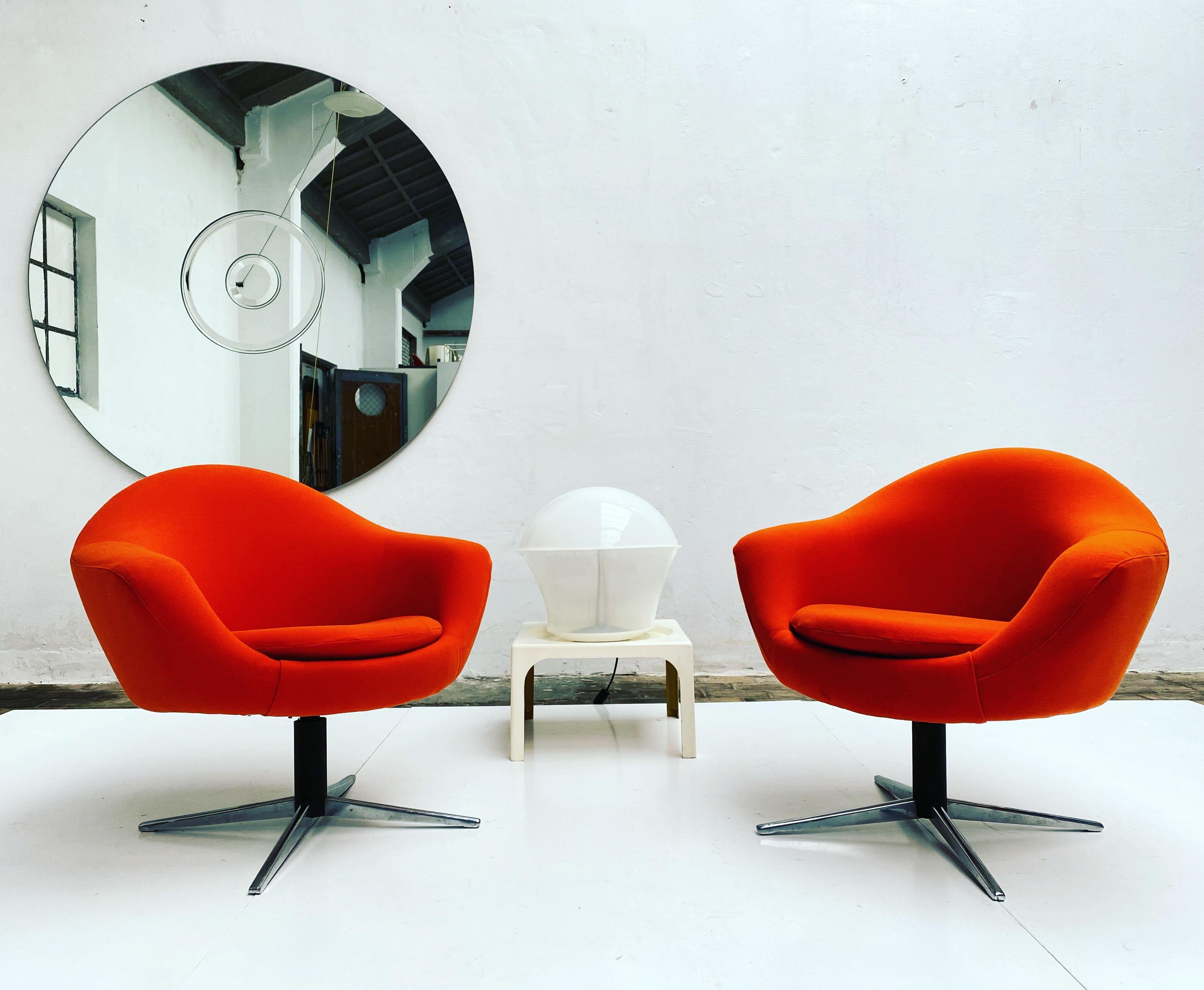 Unique set of 4 swiveling Space Age lounge chairs that were fabricated in Hungary in 1962

We have newly upholstered this set with an original old stock orange stretch fabric that is period matching to these chairs

For a Space Age styled