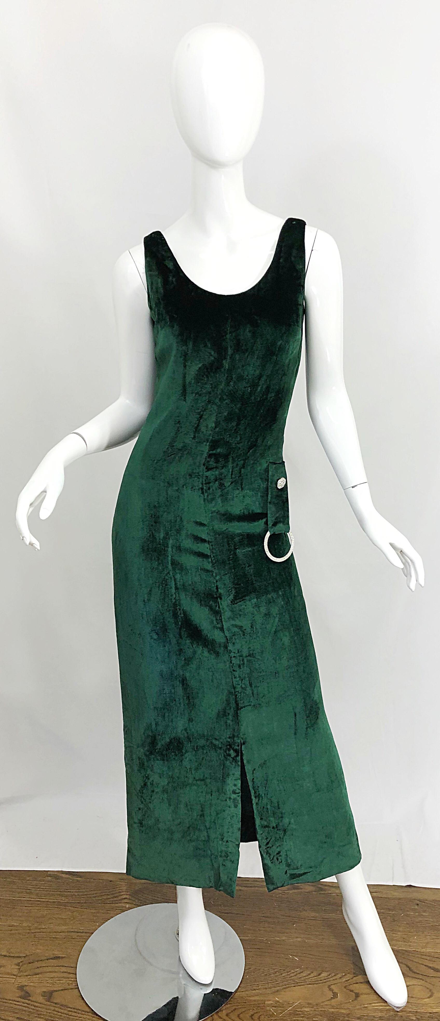 Demi Couture hunter / forest green silk velvet sleeveless evening gown! Tailored bodice with rhinestone details and rhinestone encrusted ring at left waist. Slit up the front center hem. Hidden. Metal zipper up the back with hook-and-eye closure.