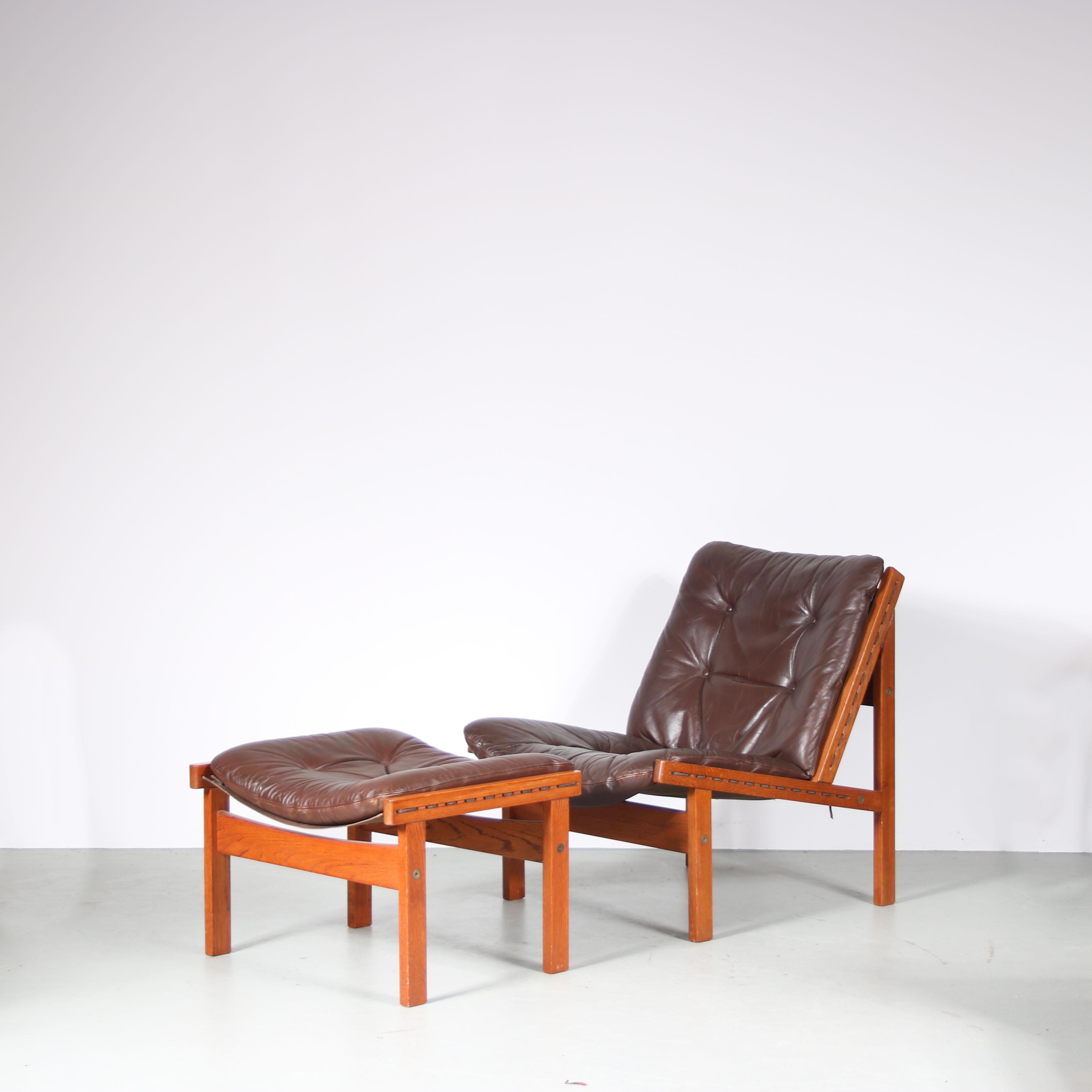 A beautiful “Hunting” chair with matching ottoman (foot stool) designed by Torbjorn Afdal and manufactured by Bruksbo in Norway around 1960.

Both pieces are made of high quality wood in a nice warm brown colour. The seat and back of the chair as