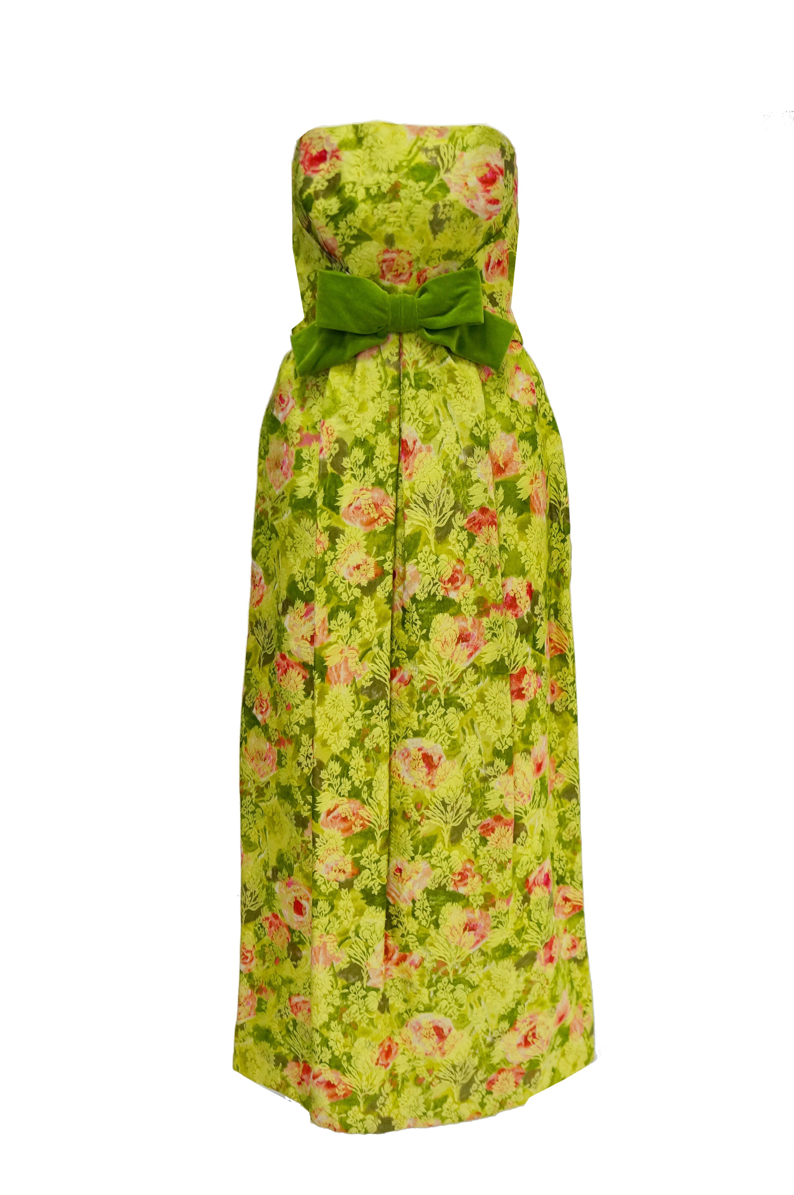 Picture perfect apple green empire waist evening dress by San Francisco's illustrious I. Magnin! This floor length gentle A - line evening dress features a pleated bust and cinched waist accented by a soft green velvet bow. The gorgeous pink