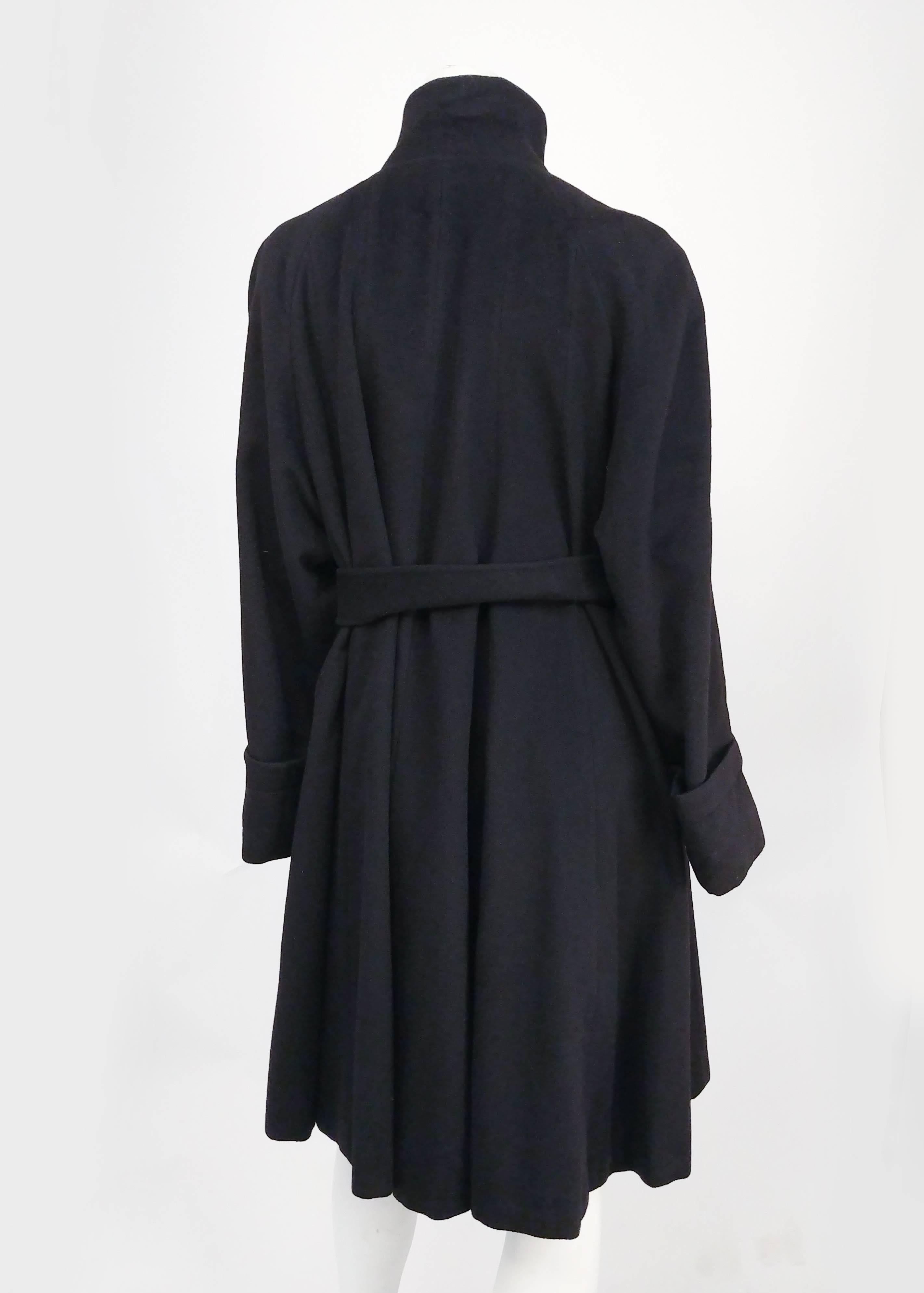 1960s Black Cashmere Wool Coat. Matching waist tie included. Loose, draped fit and A-line silhouette. Hidden buttons at front, high collar. Aprox. size 10-14