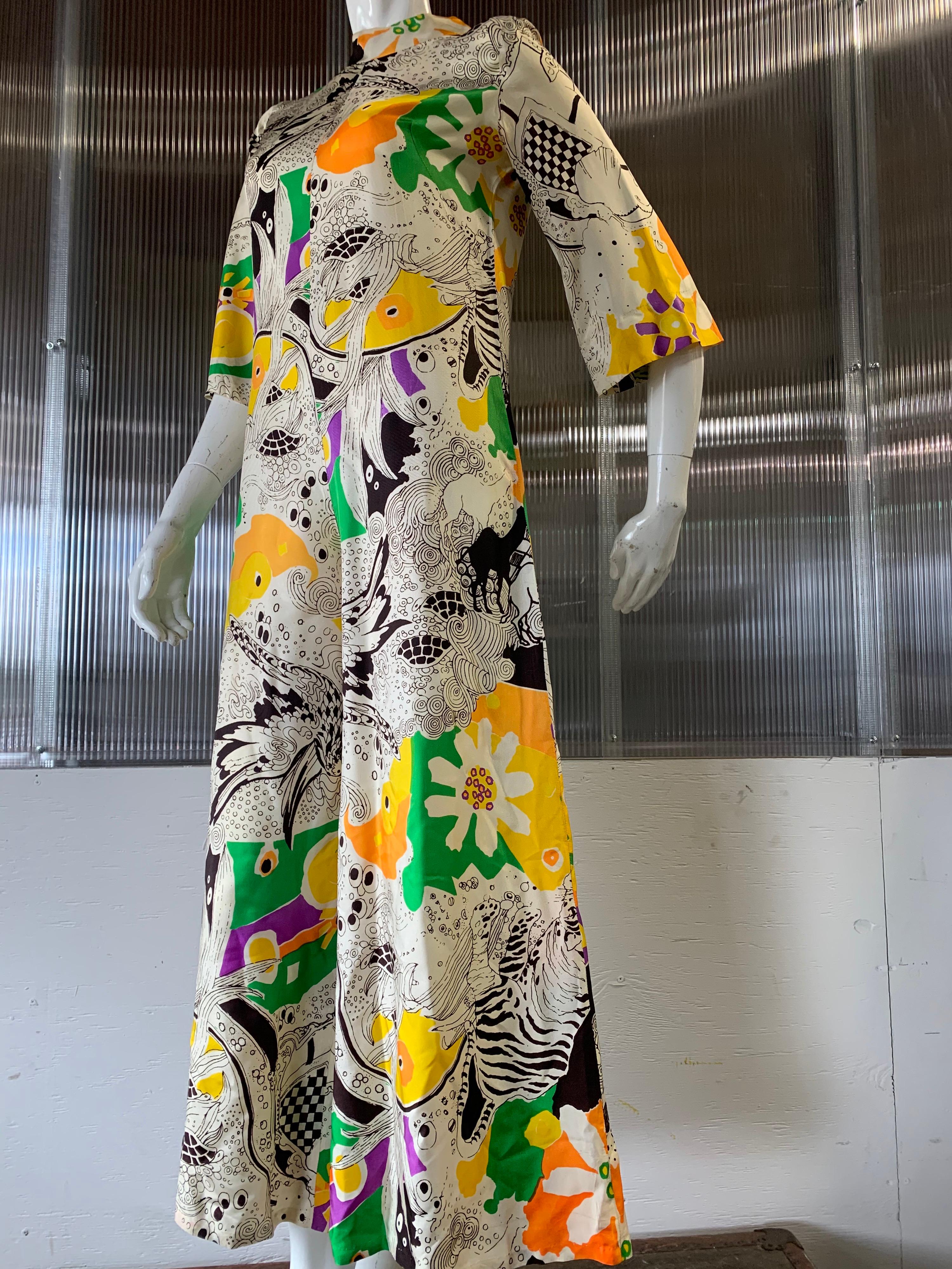 A fun 1960s I. Magnin Mod cropped jumpsuit with mock turtleneck in a stylized floral print:  Black and white with splashes of orange, green, purple and yellow. Zippered back. Full legs. Size 6. 