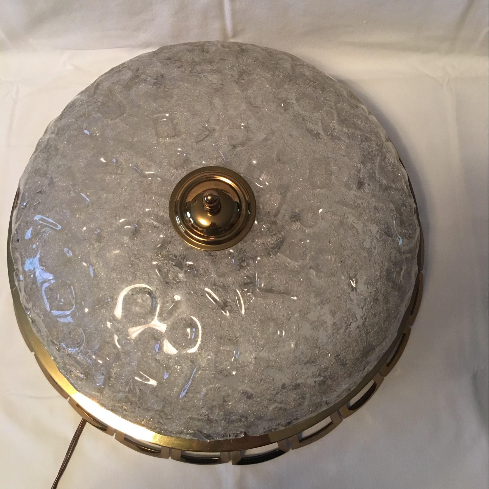 Beautiful ice glass ceiling flush mount Art Deco lamp with a lovely open brass ring surrounding the fixture. Manufactured with highest German quality by Schroeder Leuchten. It requires four E 26/27 European Edison Bulbs up to 60 watts each. In good
