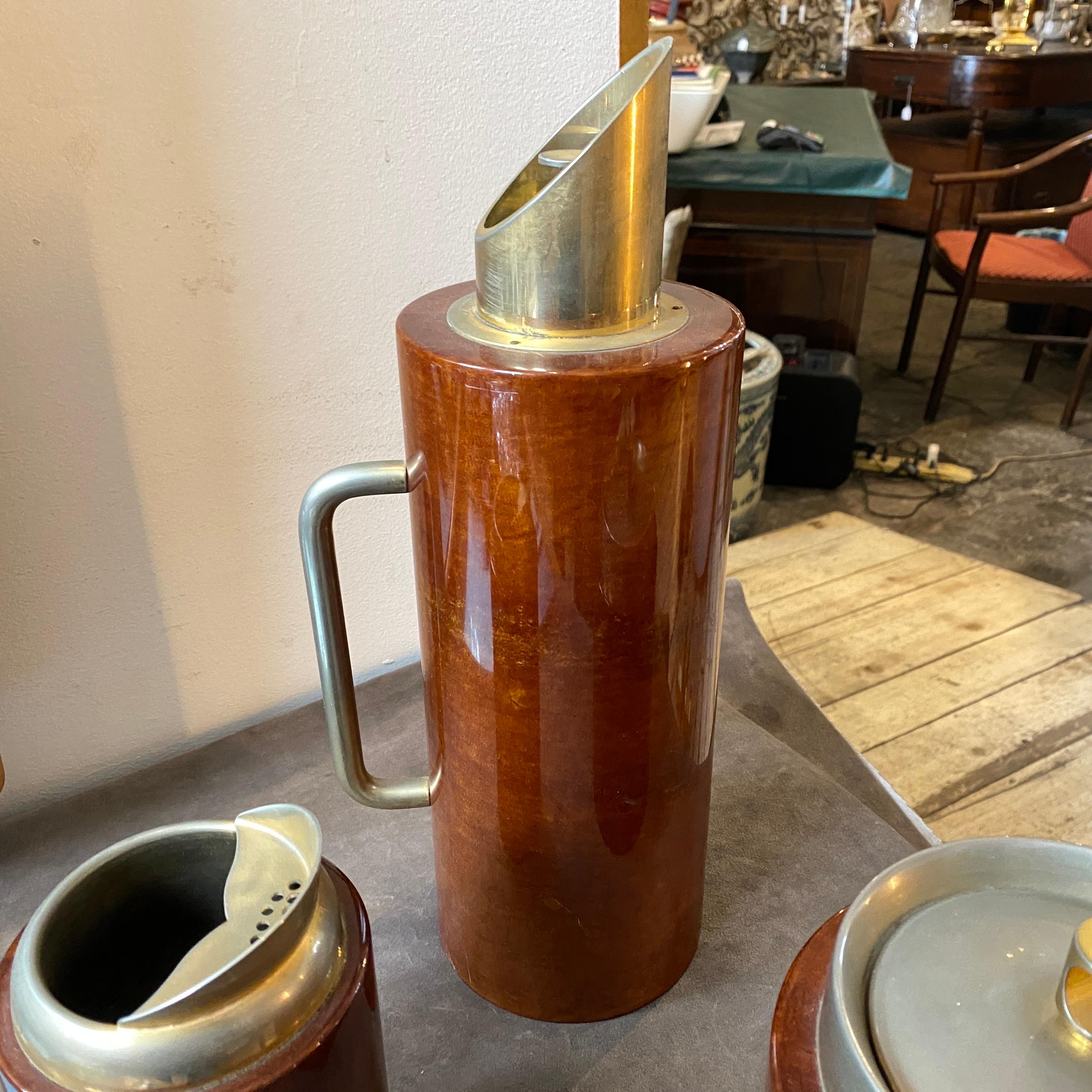 An amazing barware set made in Milano in the Sixties designed and manufactured by Aldo Tura. The brown goatskin it's in perfect conditions, brass has signs of use and age. It's composed by a thermos carafe, an ice bucket and a mixer, all labeled on