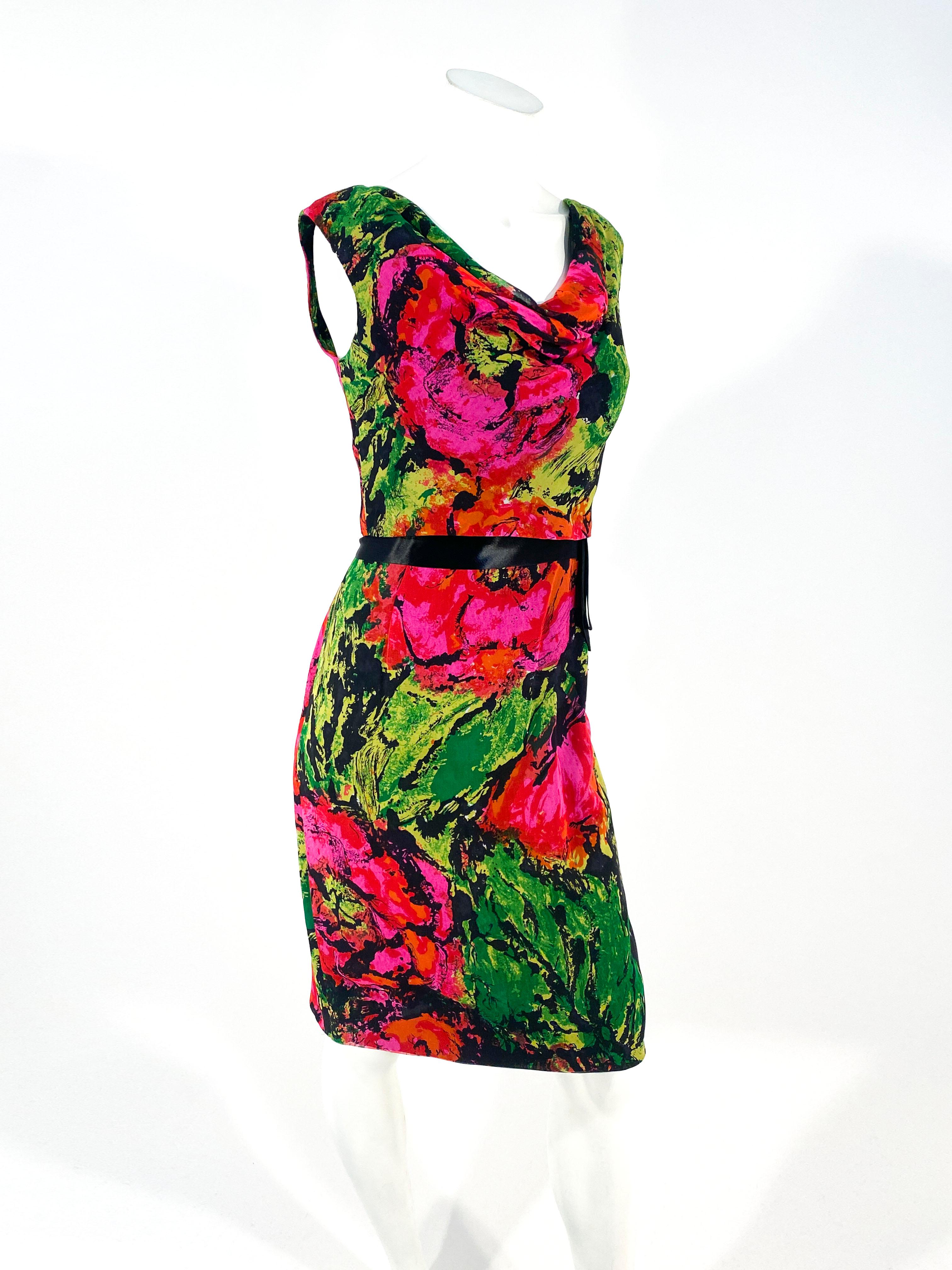 1960s Impressionistic floral printed dress with matching shell top made of silk chiffon. The shell top has a boat neckline that is layered over the dress that has a satin black satin waist sash. The print features red, magenta, green, black, and