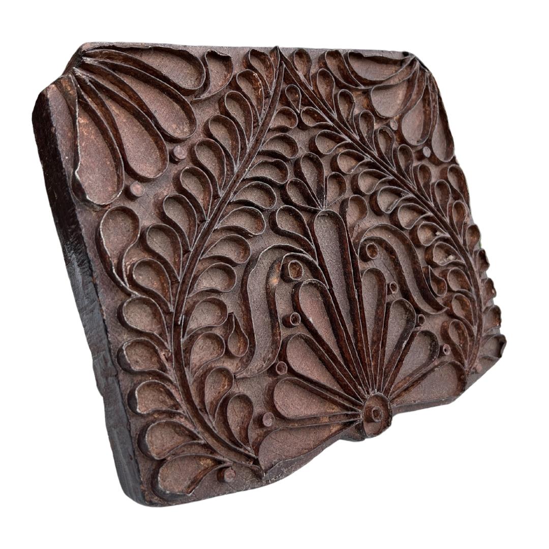 Circa 1960s India. 

A vintage wooden printing block from India. It is hand-chiseled by artisans and used to hand print textiles. This block features a pretty heart/floral design and is made out of teak.

Dimensions: 8.25