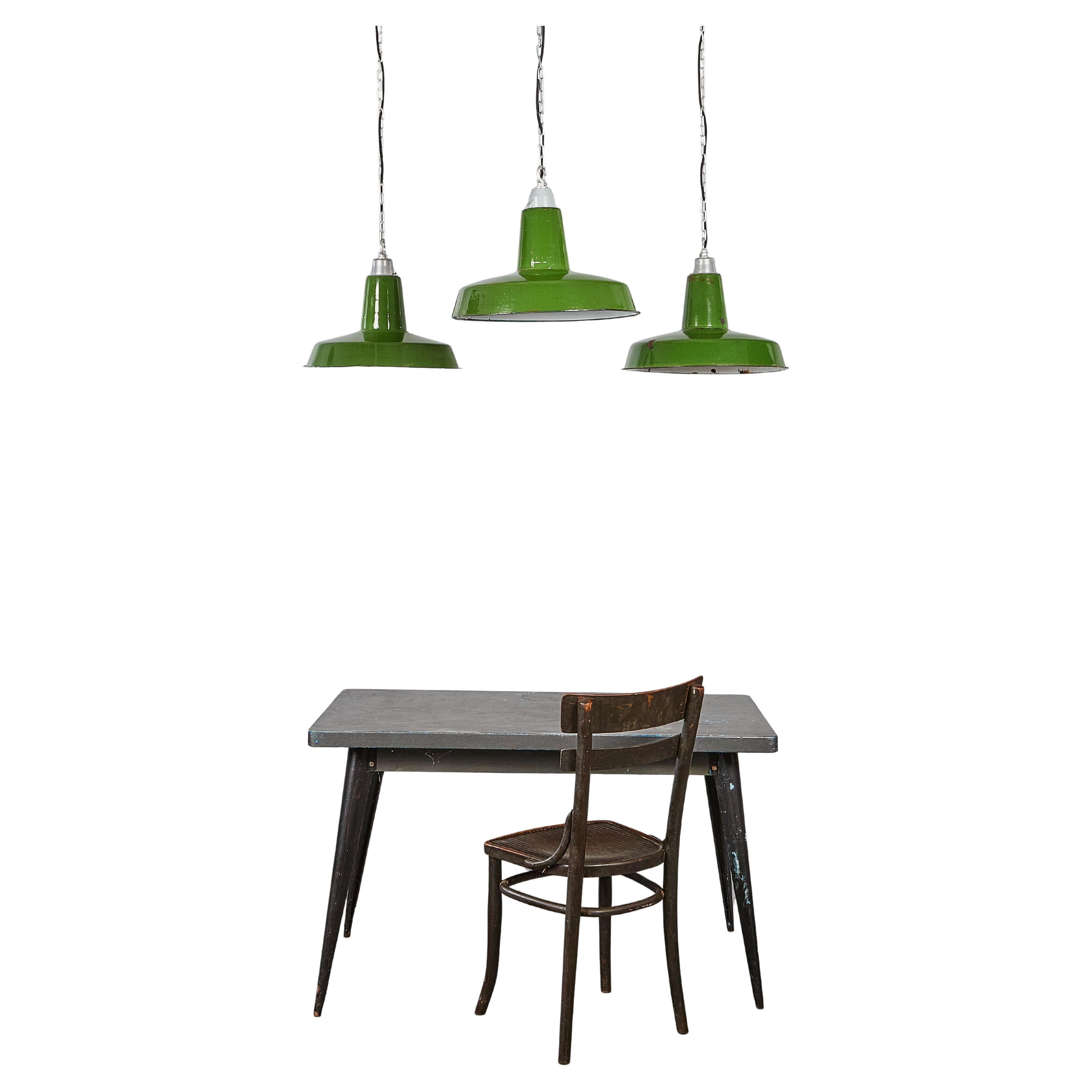 1950's Industrial Green Pendant Lamps - Good Quantity Available. 

Listing is for one lamp. Made from spun and enamelled steel with grey tops. The grey tops vary is style slightly. The lamps were covered in paint, grease and dirt which was removed