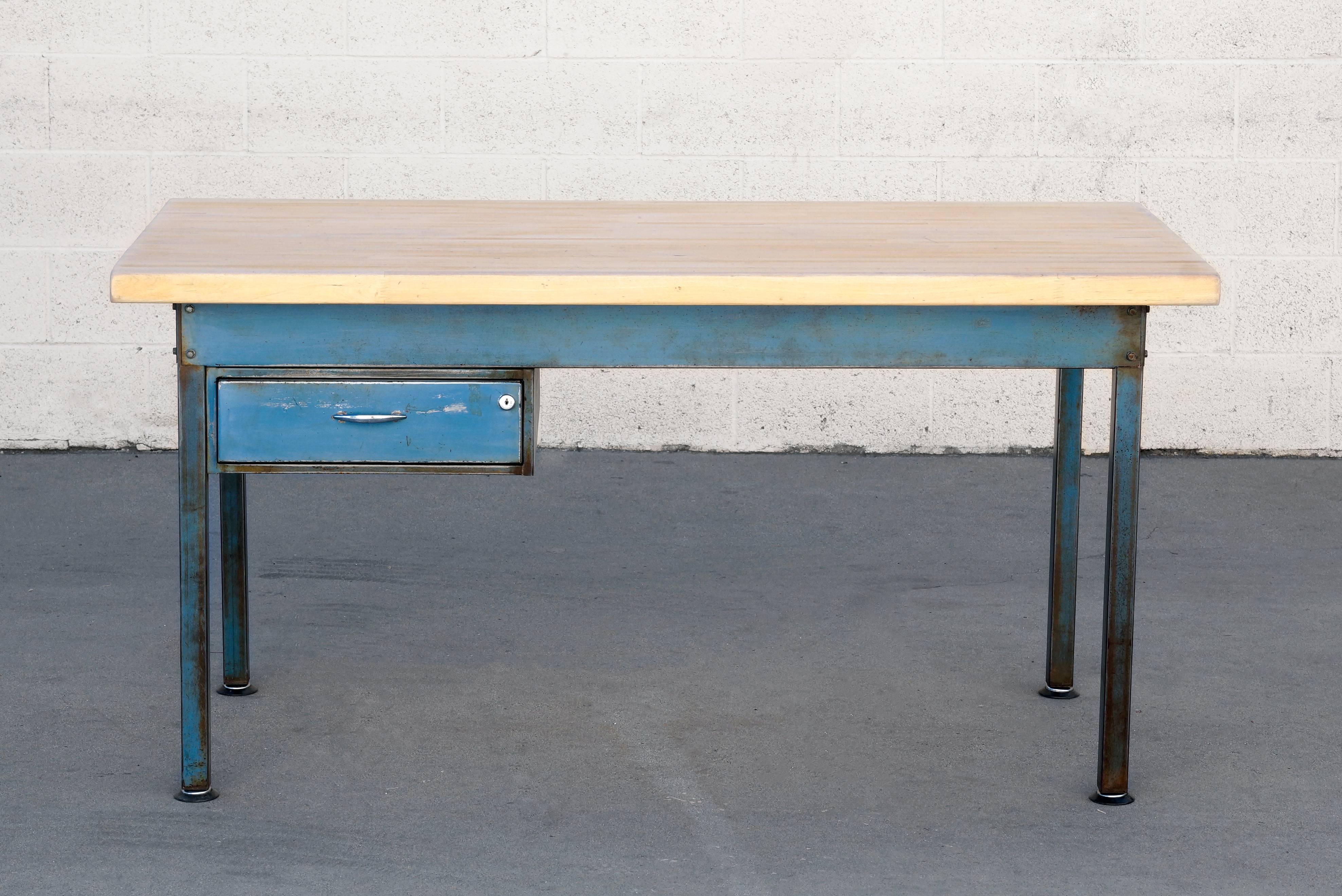1960s Industrial steel workbench with a gorgeous blue patina. We added a reclaimed maple top and finished the frame with a light lacquer topcoat and adjustable levelers. Put this excellent multifunctional piece to use in your kitchen, office, studio