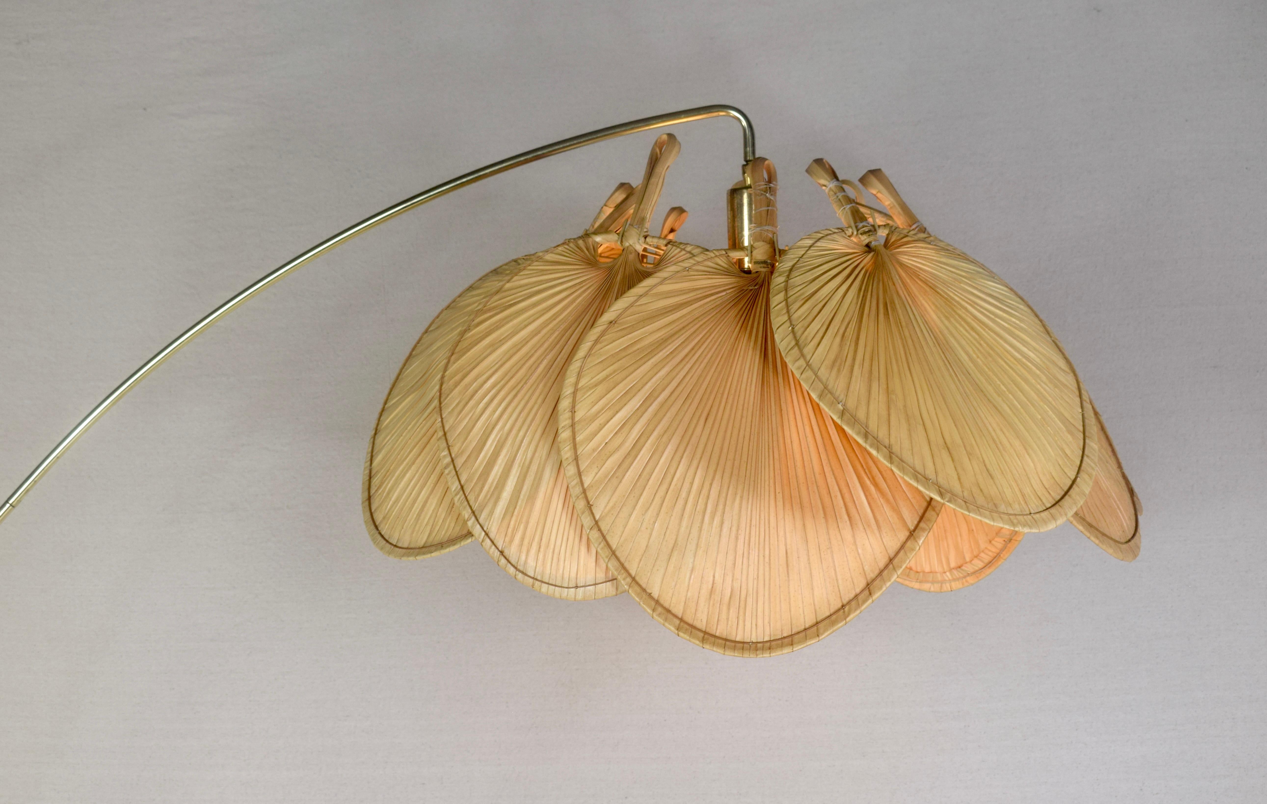 1960's Arc Floor Lamp consisting of 12 rattan palm leaves shade, brass arc rod attributed to designer Ingo Maurer. An unusual design casting warm ambient light; all original.