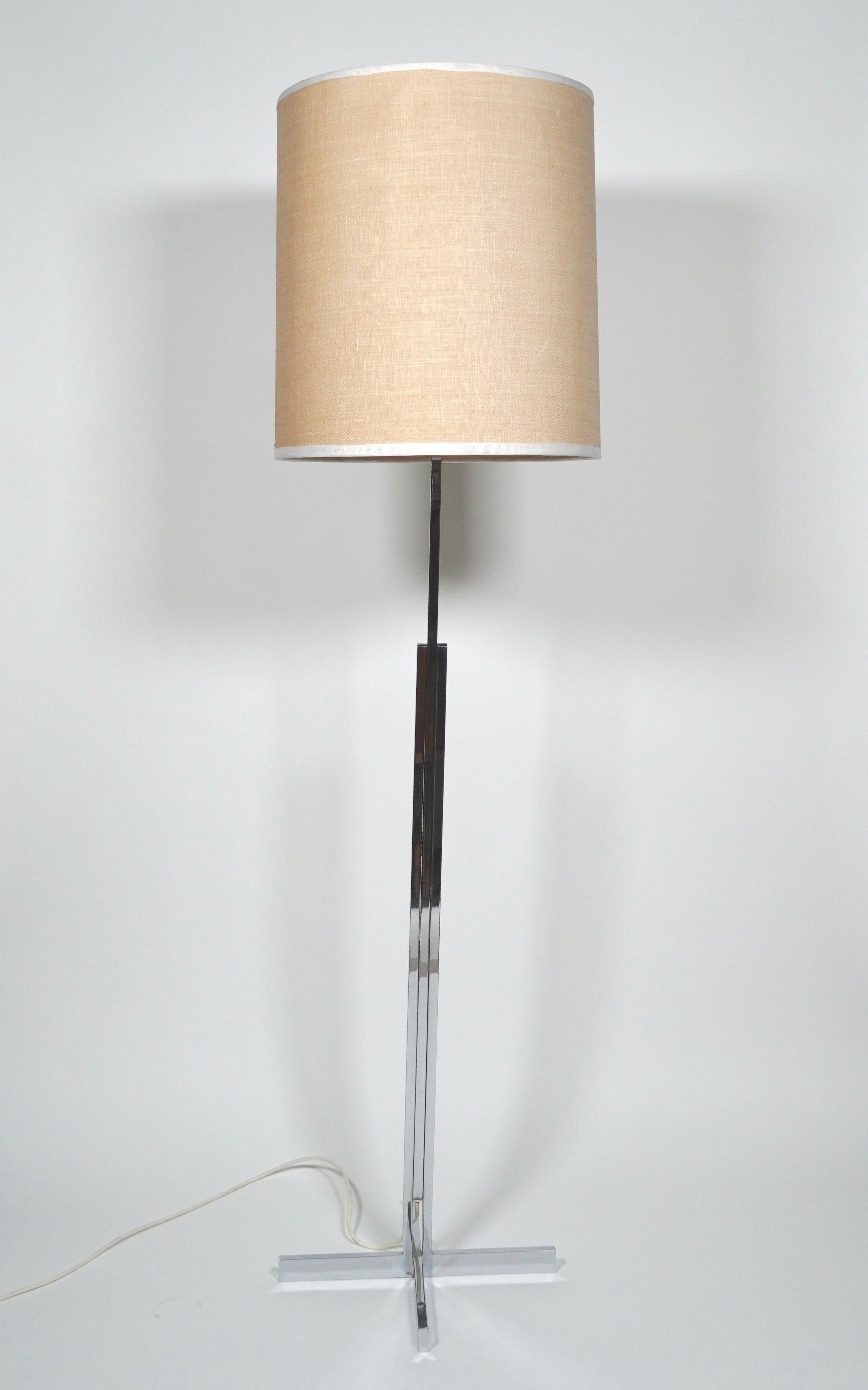 International Style chrome and linen floor lamp circa 1960s from Switzerland. Consisting of a three part square tubing chrome frame resting on a four point rectangular base creating a slender profile. The lighting mechanism is a three way light