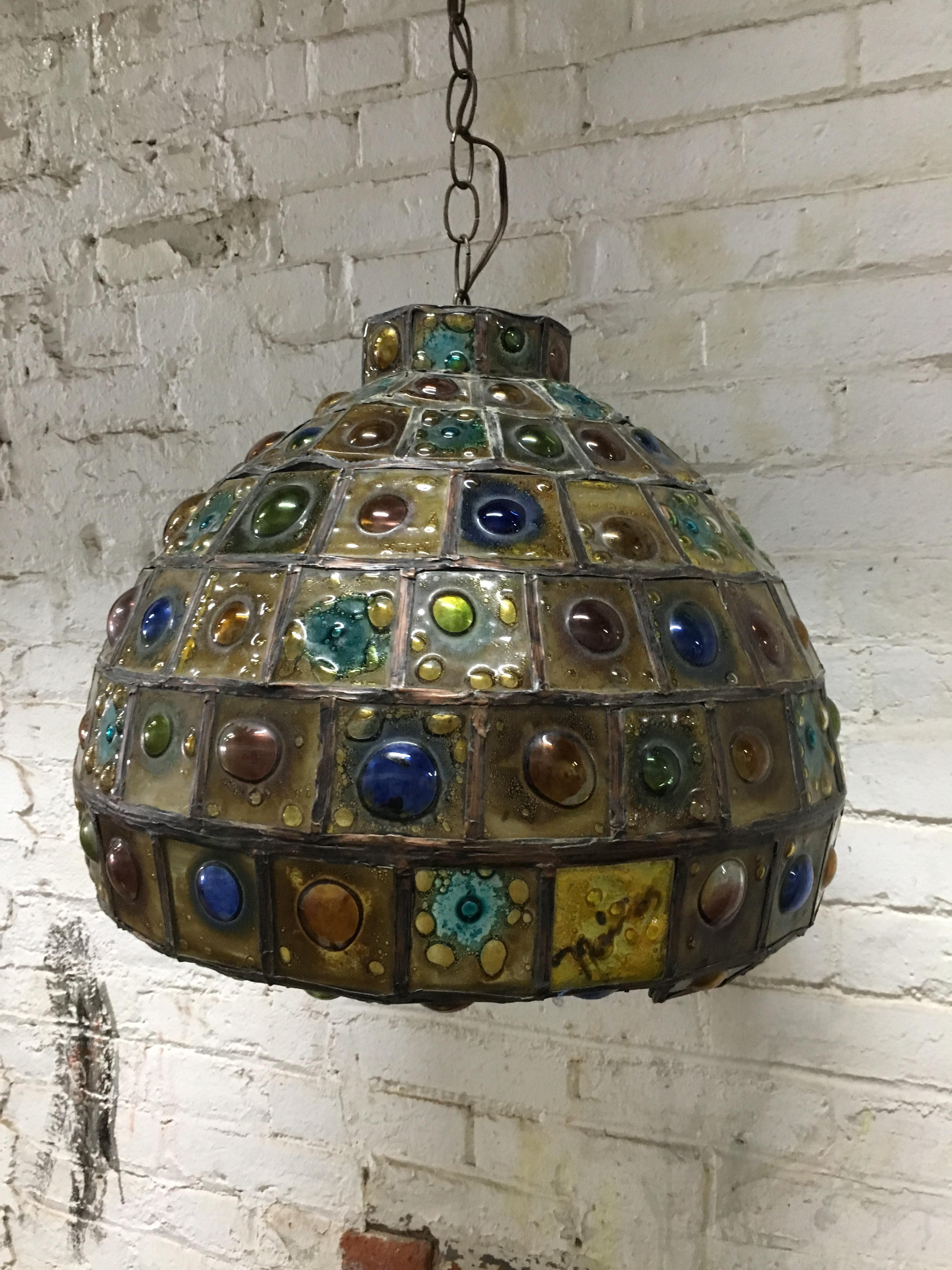 Beautiful jeweled leaded glass pendant light fixture. Wonderful individually blown art glass tiles, circa 1960-1970. Original working wiring. Designed by Felipe Delfinger for Feders.

Approximately 14