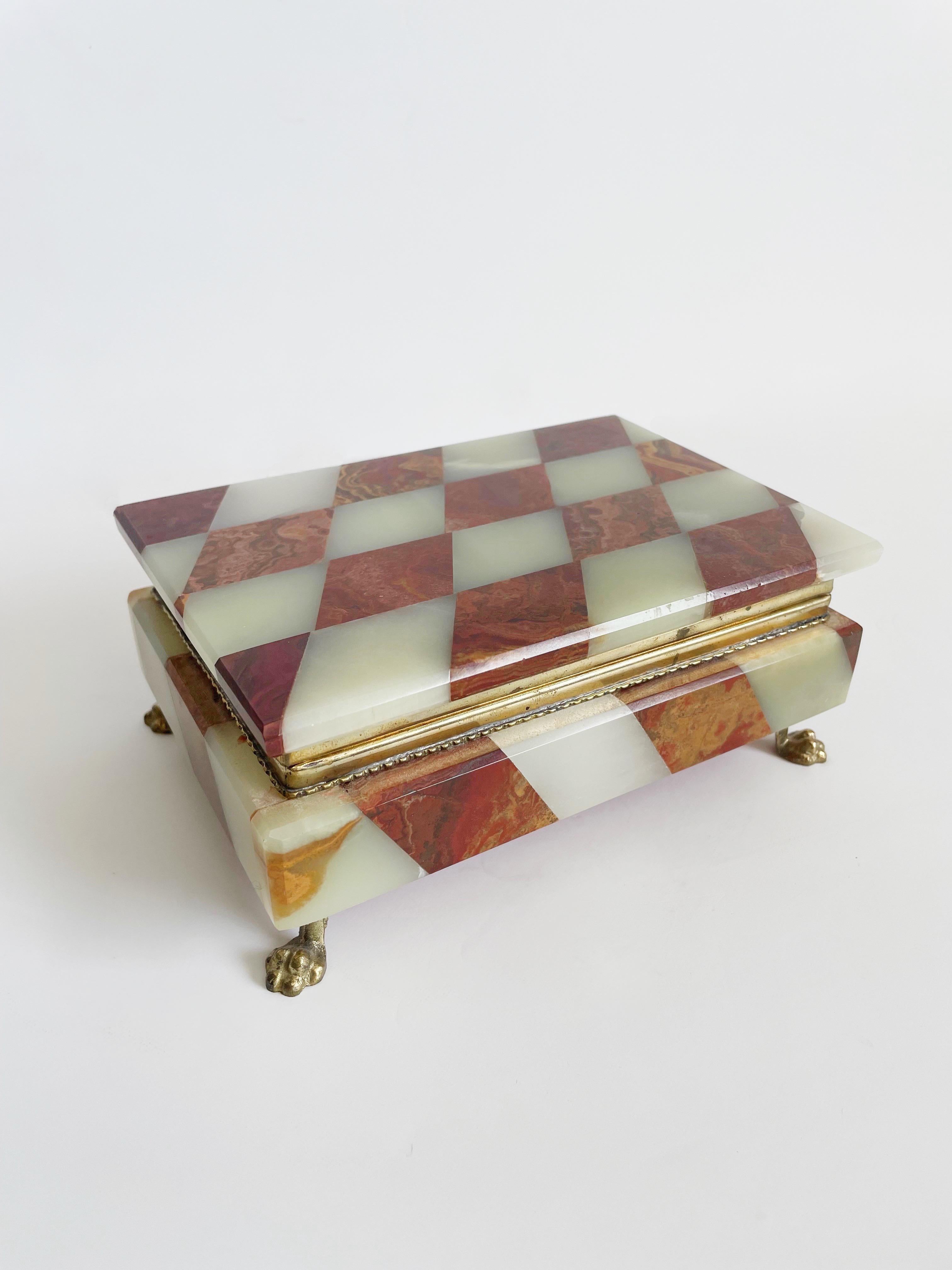 Opulent Italian alabaster box with red agate and a red velvet lining to match. Features brass claw feet.