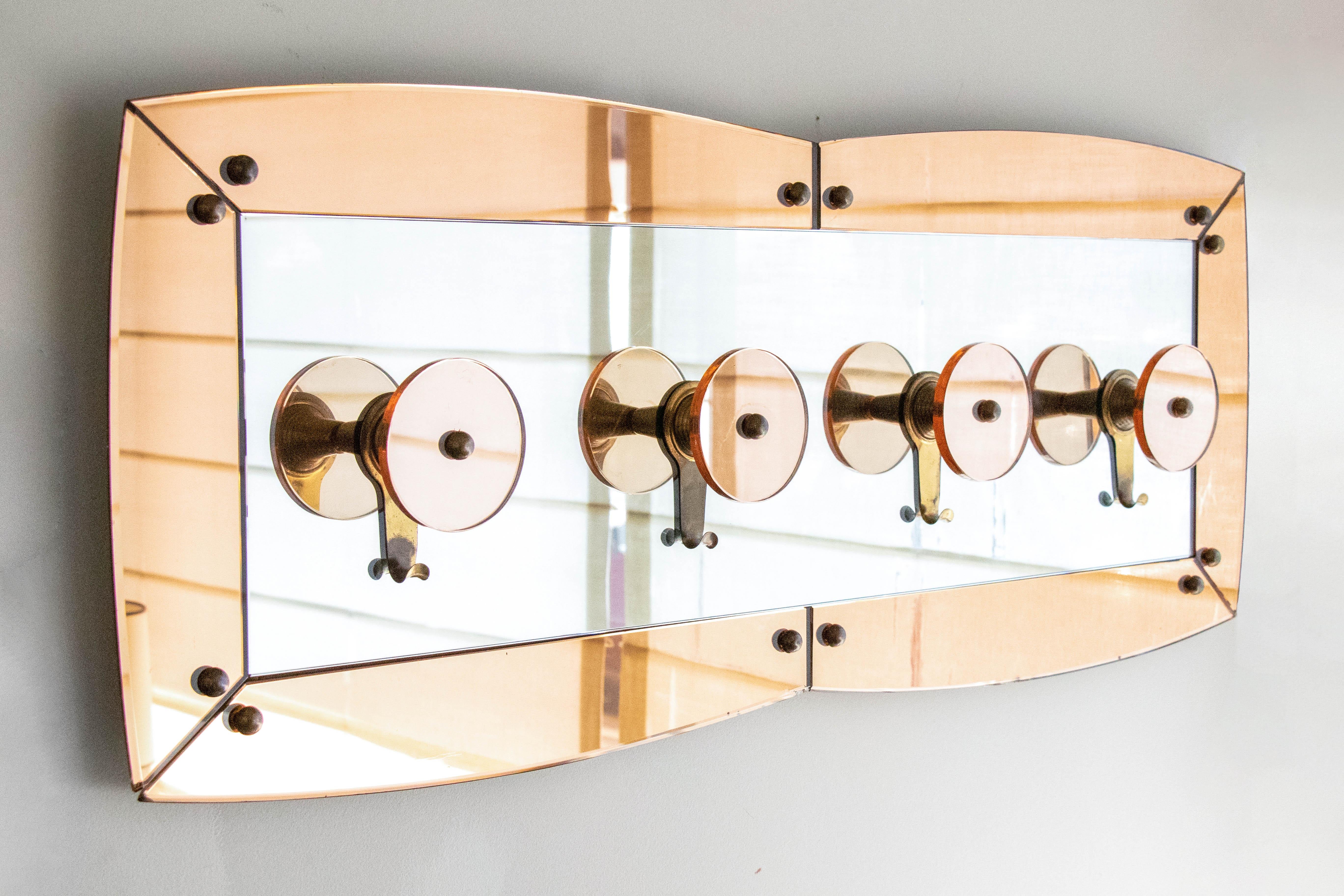 Beautiful large scale Italian 1960s coat rack by Cristal Arte. Amber mirrored frame and 4 circular mirrored hooks with brass hooks. Beautiful in an entryway or closet.
 
