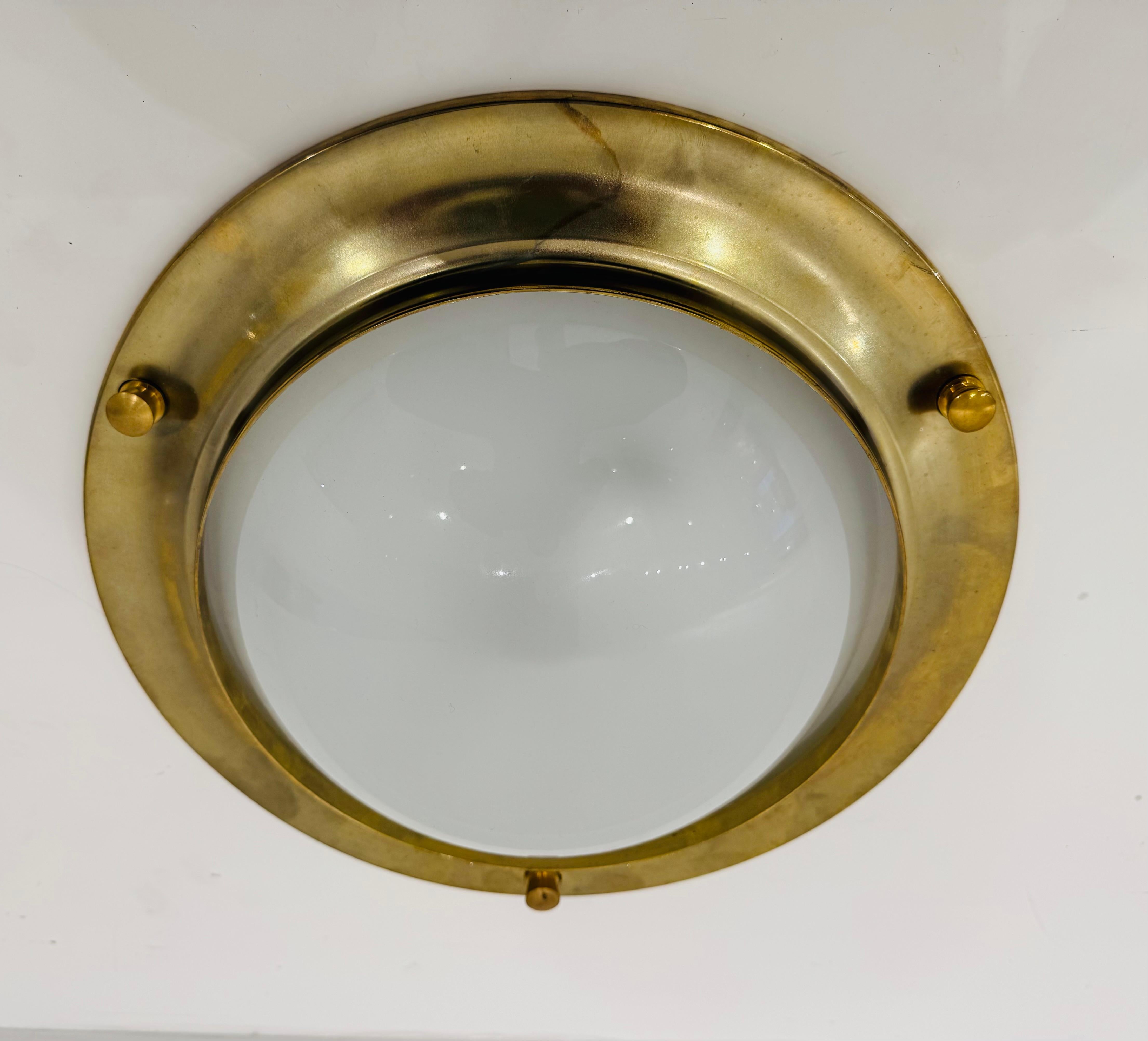 A  polished golden nautical style flush ceiling light with frosted white glass dome shades. Newly rewired. 2 standard e26 lights sockets each.
