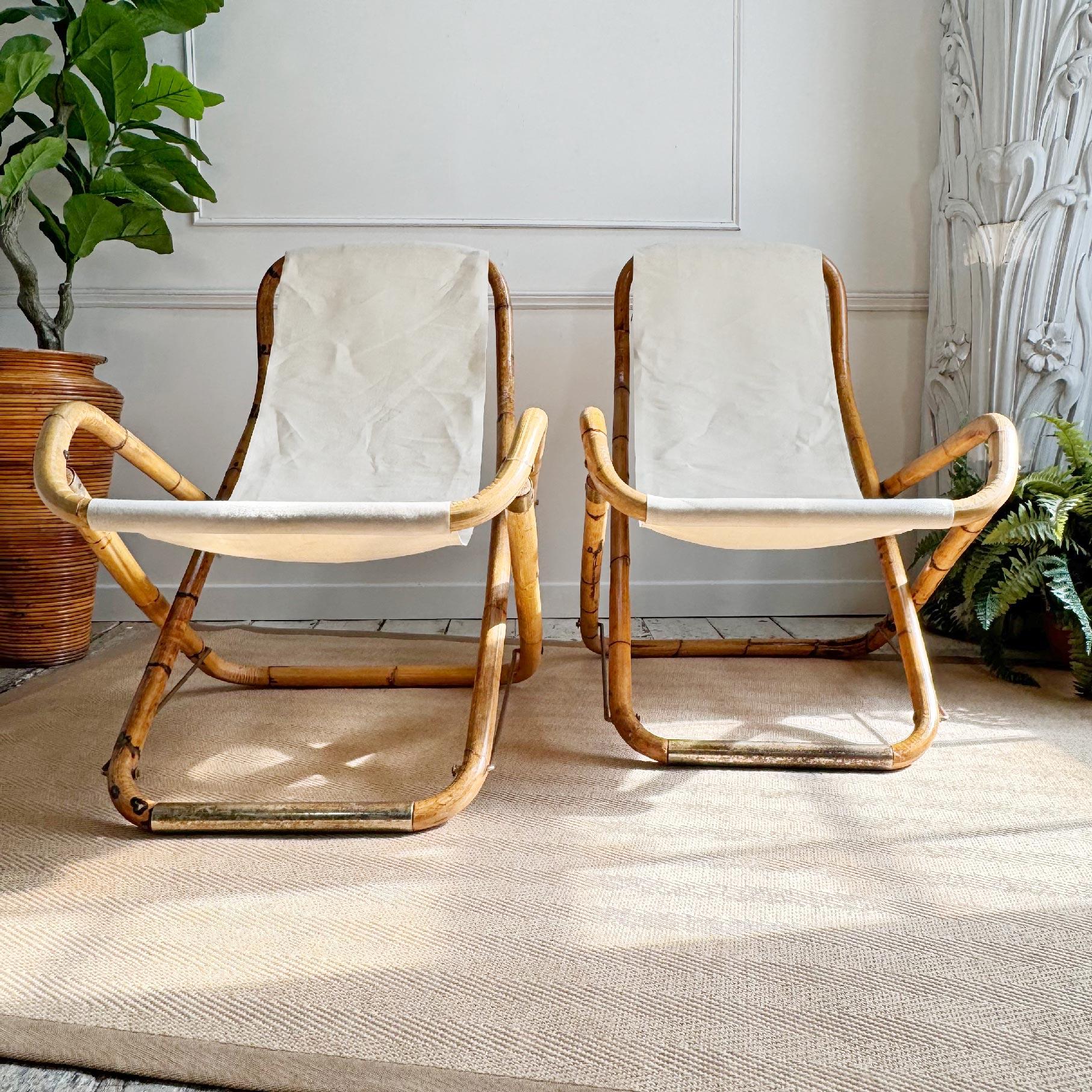 An exceptional pair of 1960's Italian lounging deck chairs, hand crafted from bamboo with brass plated foot rests and end caps, off white fabric seats. These are beautiful rare survivors and in very good vintage condition, the brass plating has