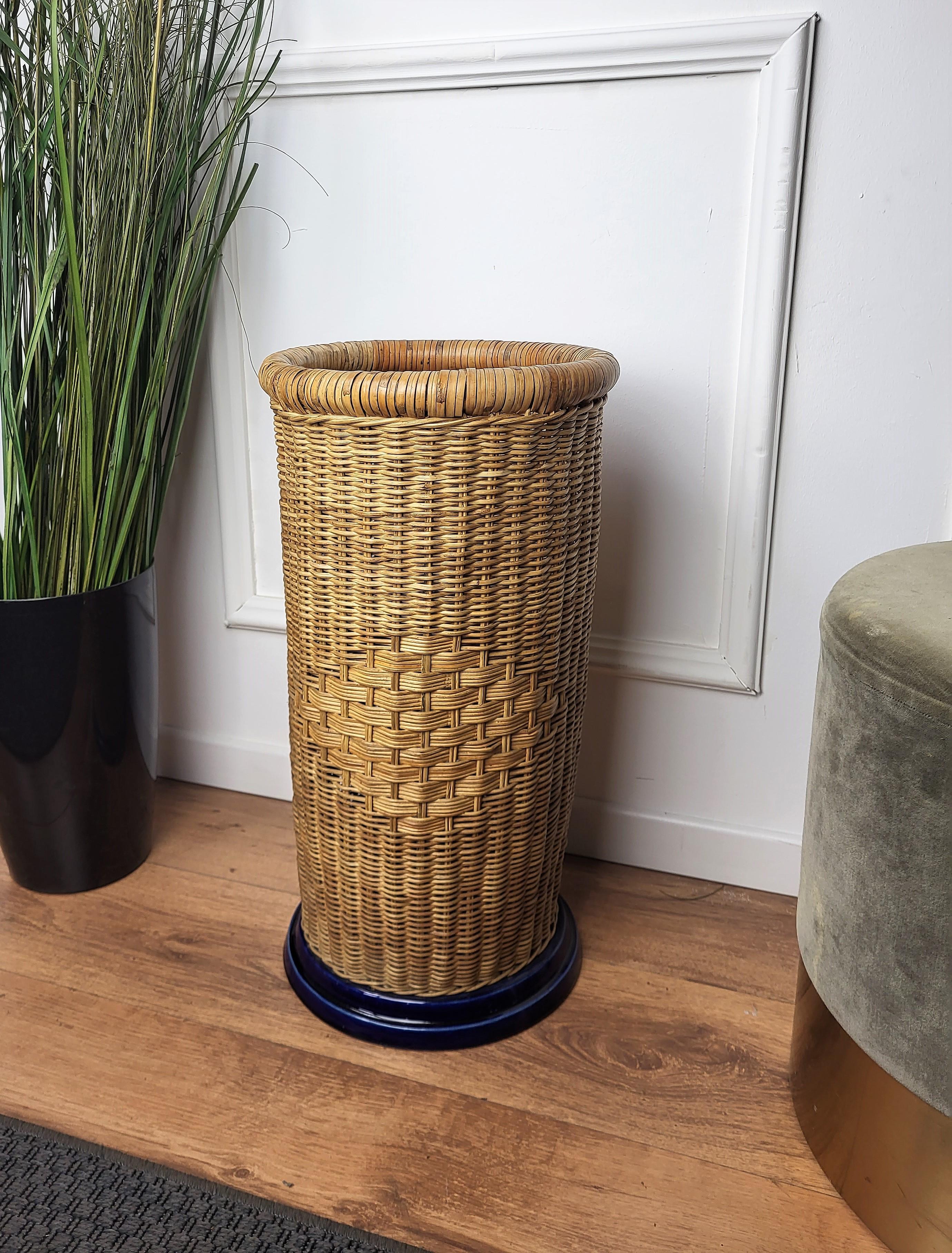 Beautiful 1960s Italian Mid-Century Modern umbrella stand rack with nice blue ceramic base. This charming piece is in the typical style of Audoux and Minet where the organic beauty of the woven materials is timeless and Classic, making bamboo and