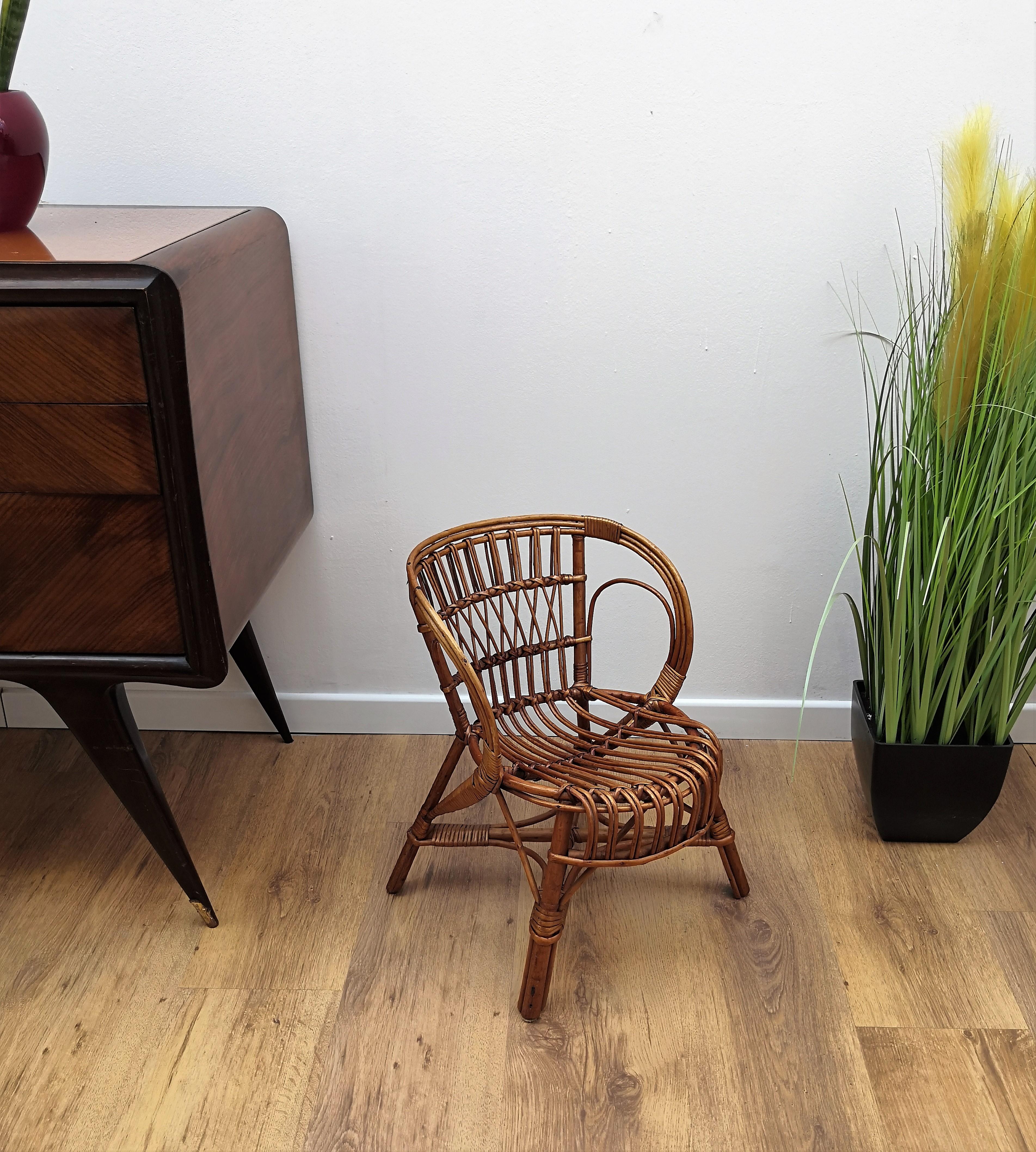 Beautiful 1960s Italian Mid-Century Modern Mini Hoop Children armchair in bamboo. This charming chair is a sweet choice for beach house playrooms and bunk rooms, where the younger set can romp around without a care in the world! The organic beauty