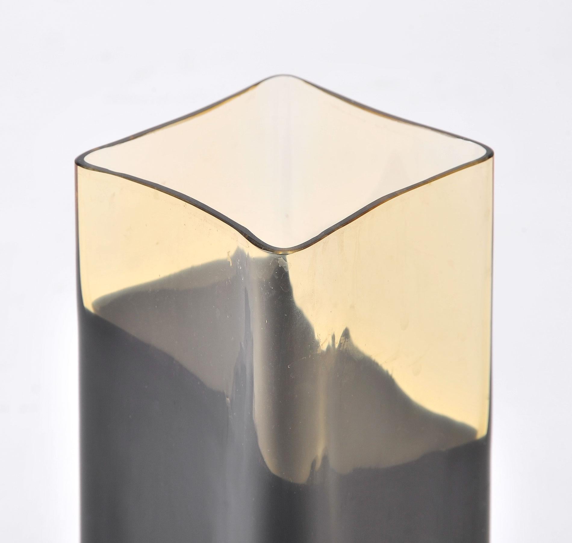 Tall rectangular vase with curved base. Amber colored glass with irregular 'dipped in black' effect.