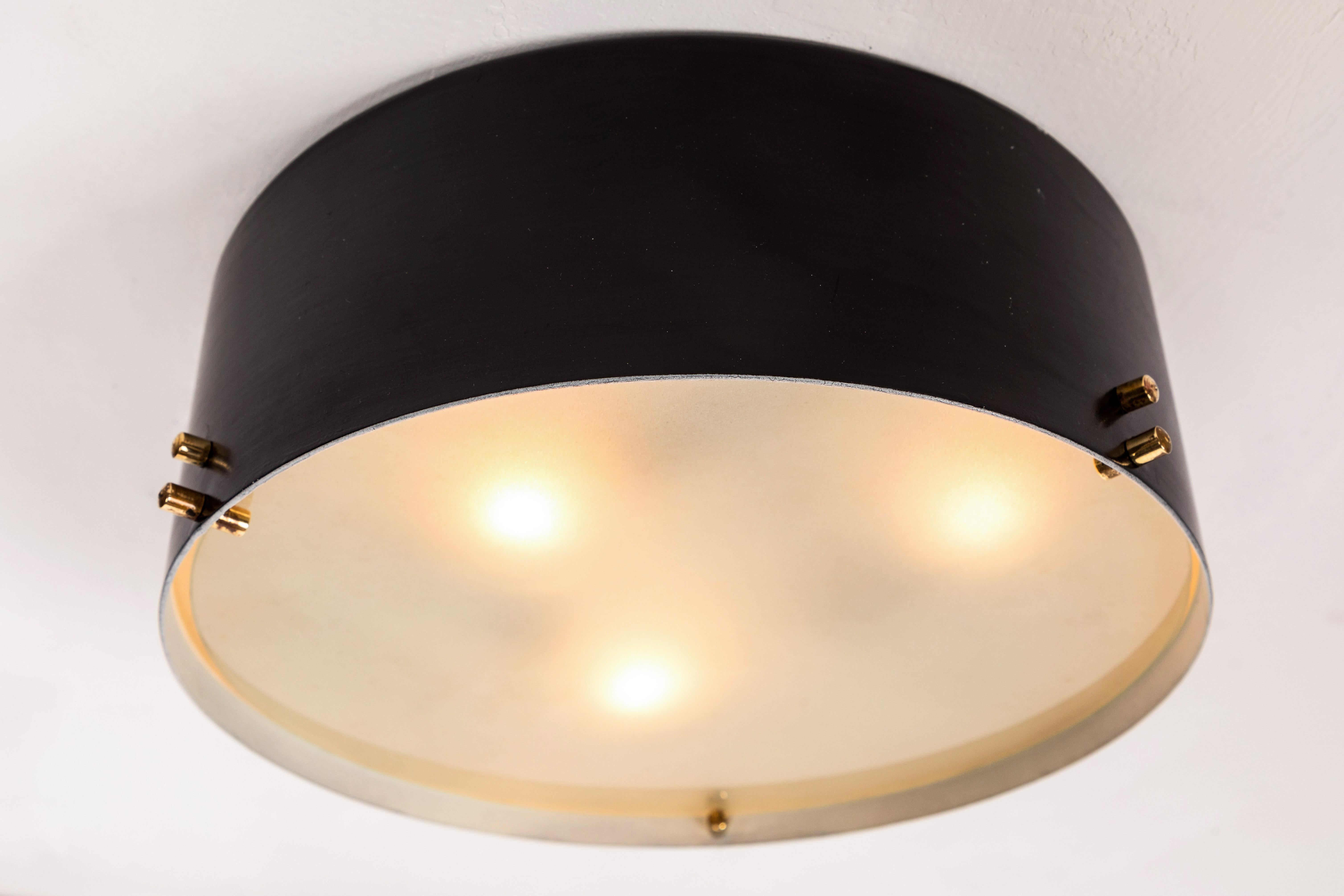 1960s Italian black and glass flush mount in the manner of Bruno Gatta. Executed in black painted metal with opaline glass and brass hardware. A sculptural and refined design characteristic of 1960s Italian design at its highest