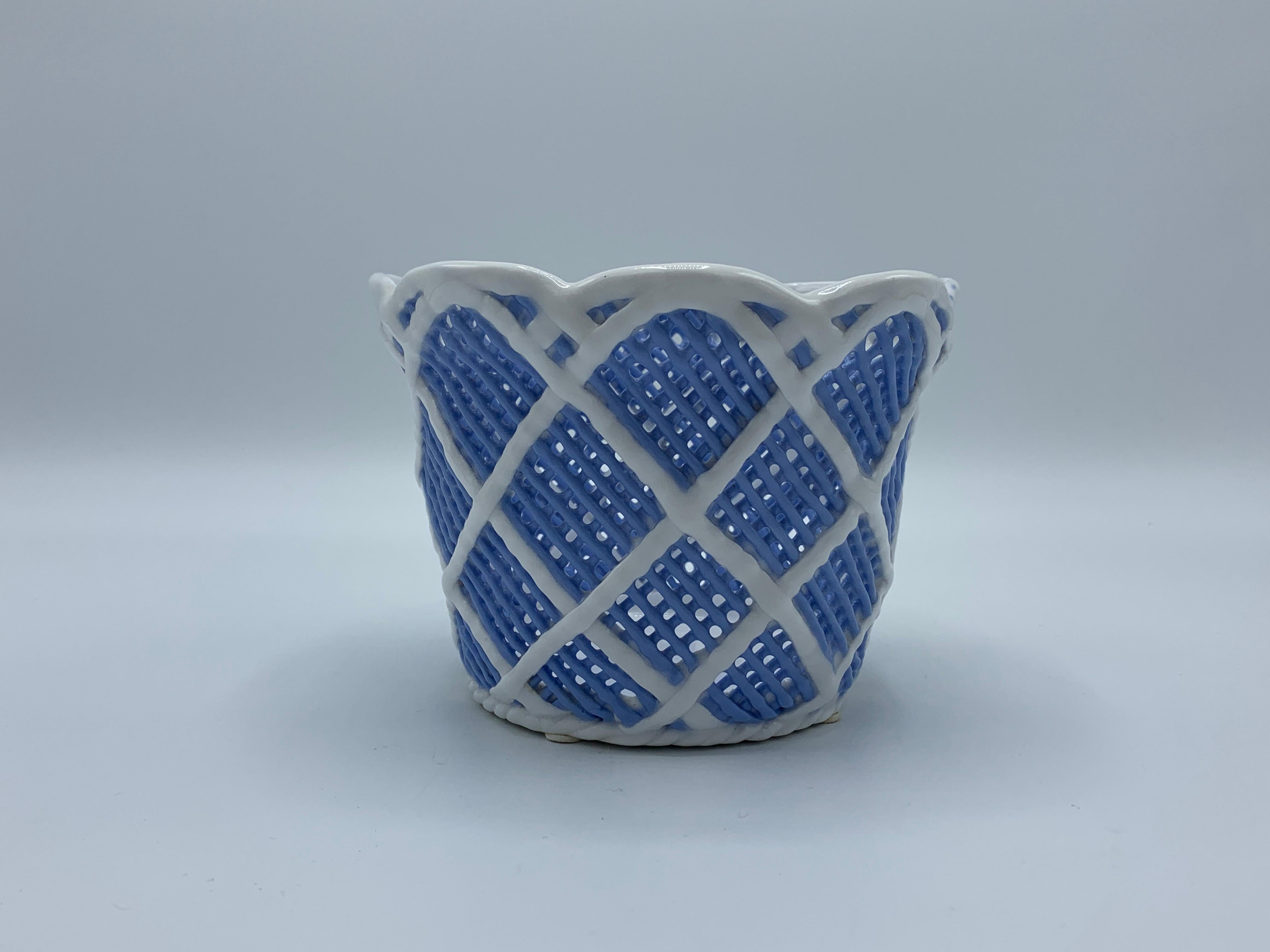 Listed is a fabulous, 1960s Italian baby blue and white porcelain cachepot. The piece has a gorgeous pierced basketweave motif all-over and is in exquisite condition. Extremely rare to find this color, especially in such great condition.