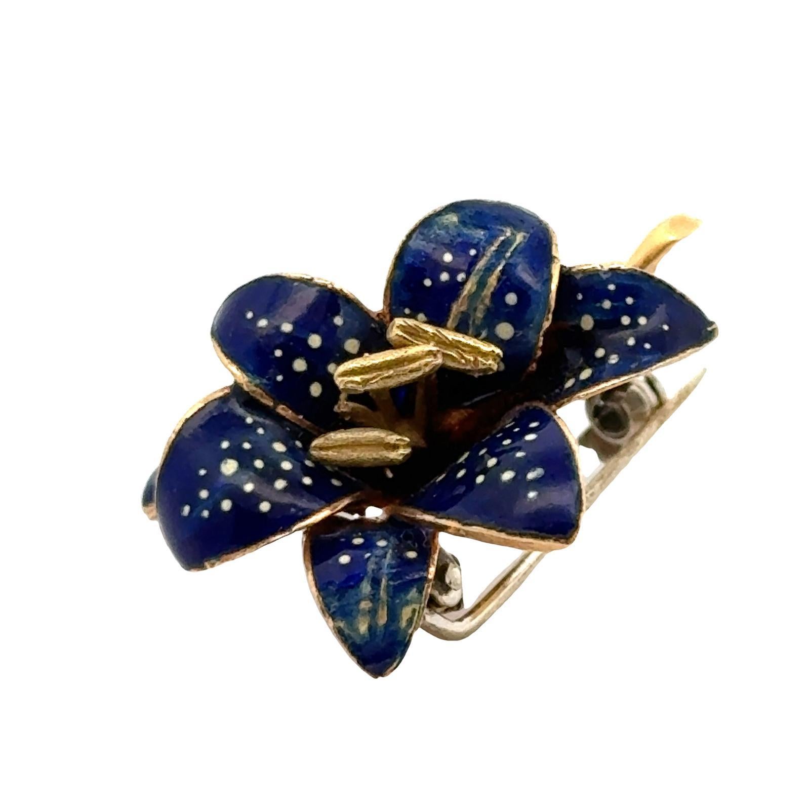 Italian blue enamel floral brooch handcrafted in 18 karat yellow gold. The vintage brooch, circa 1960's,  measures 1.00 x 1.25 inches.  Weight: 8.7 grams.