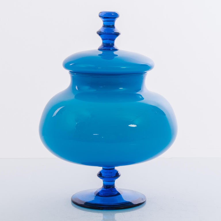 A glass goblet with lid from Italy, produced circa 1960. A bold, Blue, Venetian-style cup standing on a delicate stem, oscillating up with a concave waving stem. The history of Italian glass goes back a millennia, to the rediscovery of ancient Roman