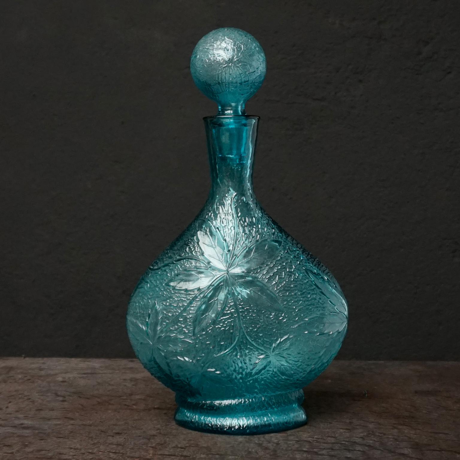 1960s Italian bright blue pressed Midcentury Modern Empoli Art-Glass carafe with leaf print and ball stopper.

Mention Italian glass and probably everyone’s mind immediately leaps to Venice and Murano.
But there is another almost equally famous