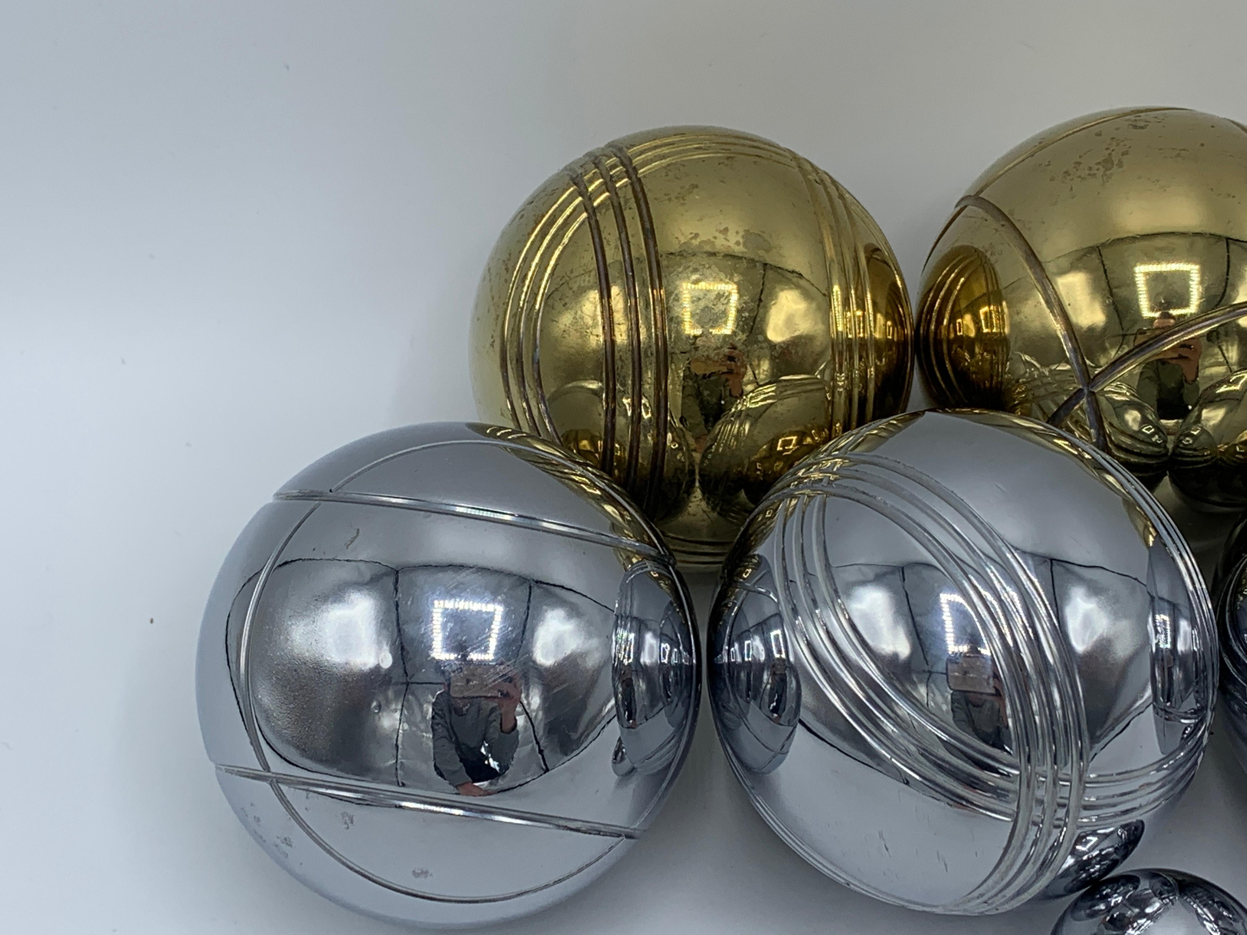 Listed is a stunning, 1960's Italian brass and chrome bocce ball set. Set includes four brass ball, four chrome ball, and one chrome pallino ball. Extremely heavy, with the whole set weighing 13lbs.